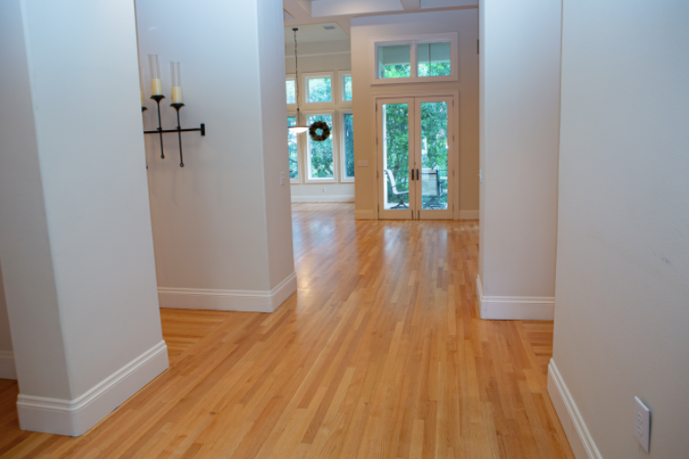 A hallway with hardwood floors and white walls