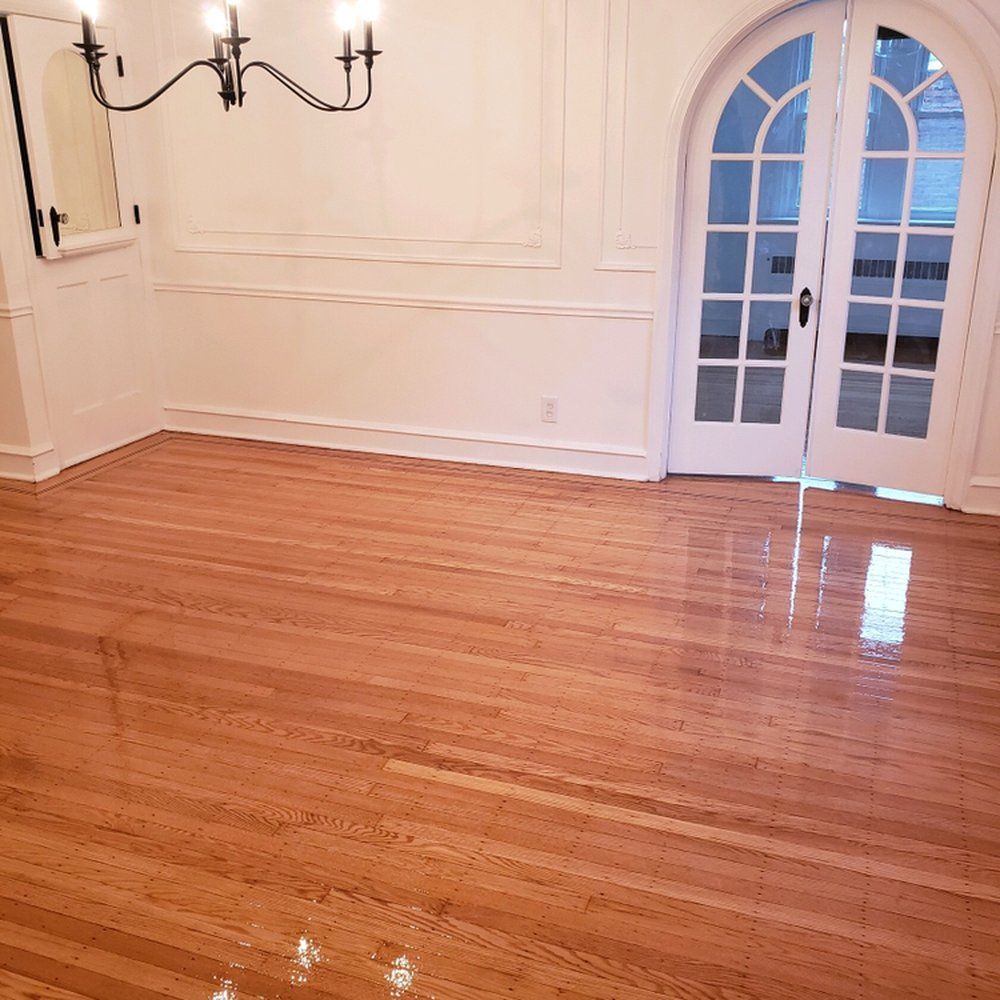A dining room with hardwood floors and white walls