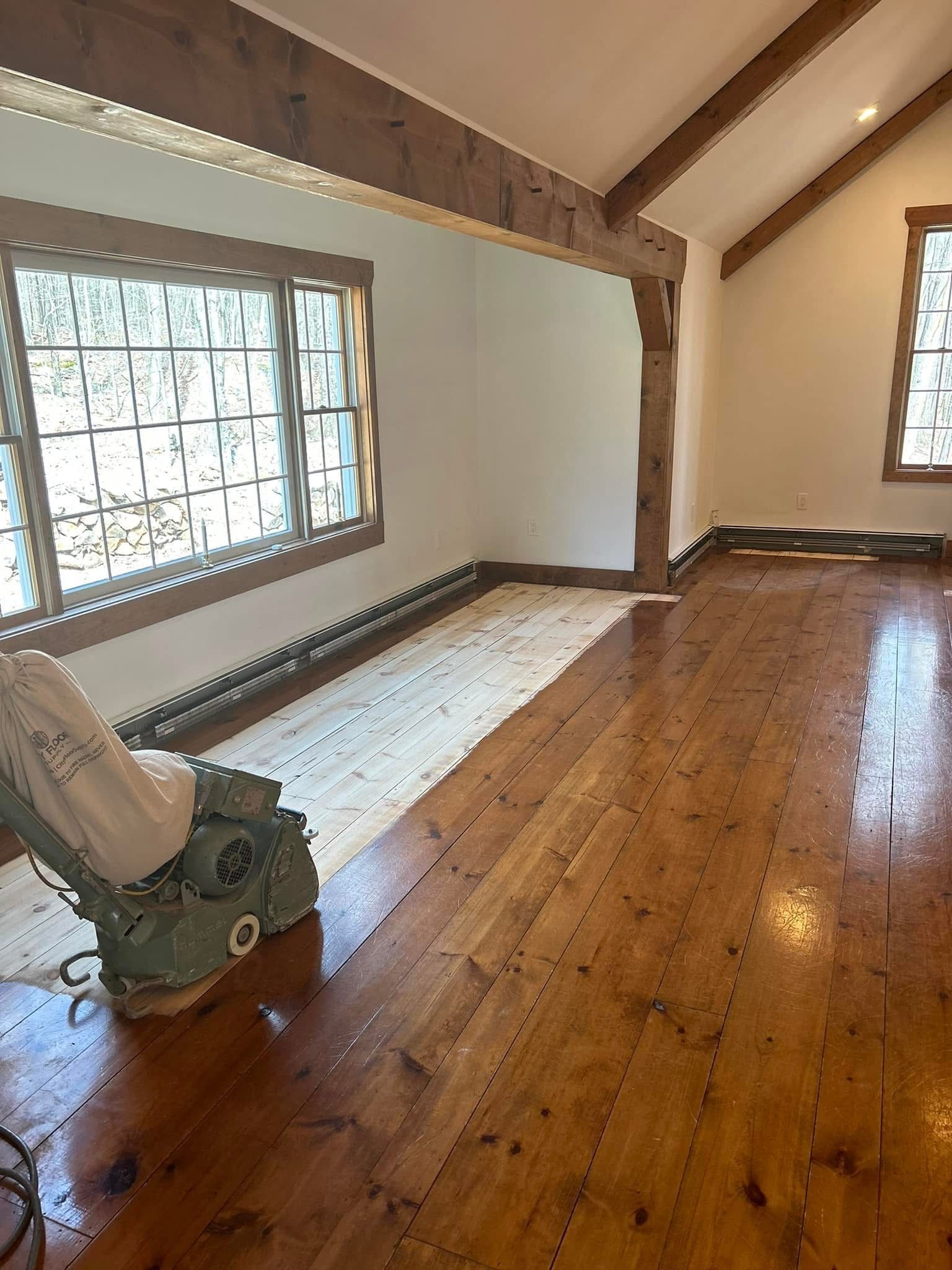 A room with hardwood floors and a chair in it.