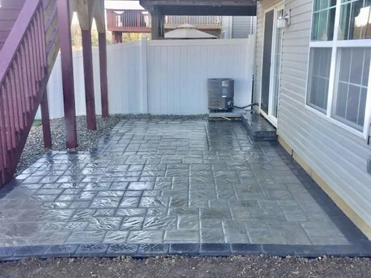 A patio with a fence and stairs