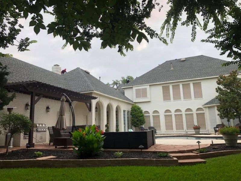 A large white house with a pergola and a swimming pool