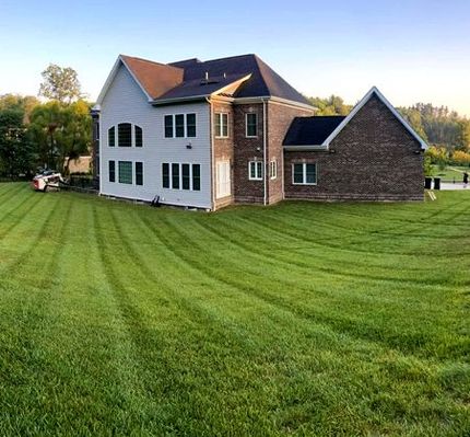 Large house with a lush green lawn
