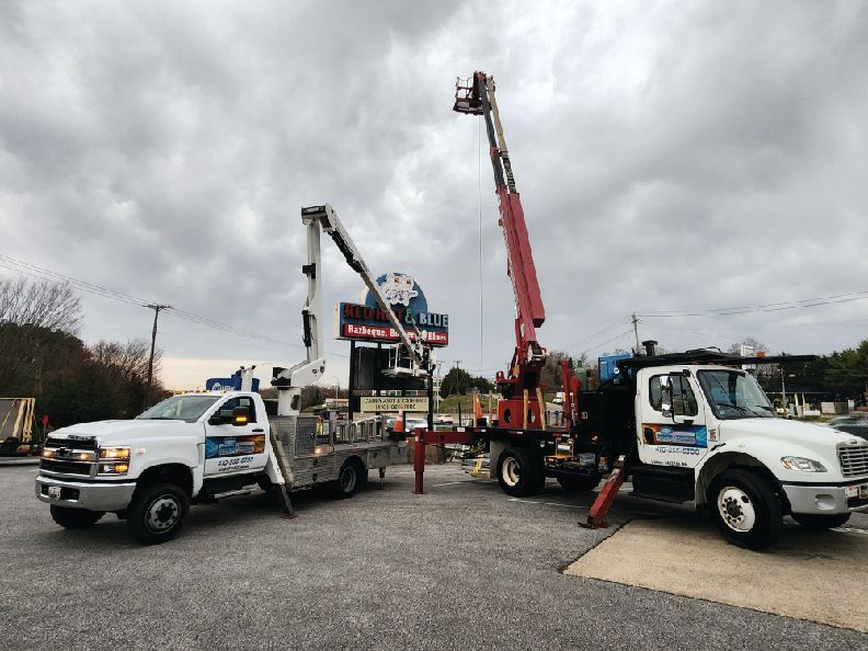 bucket trucks for the Red Hot & Blue storefront sign installation
