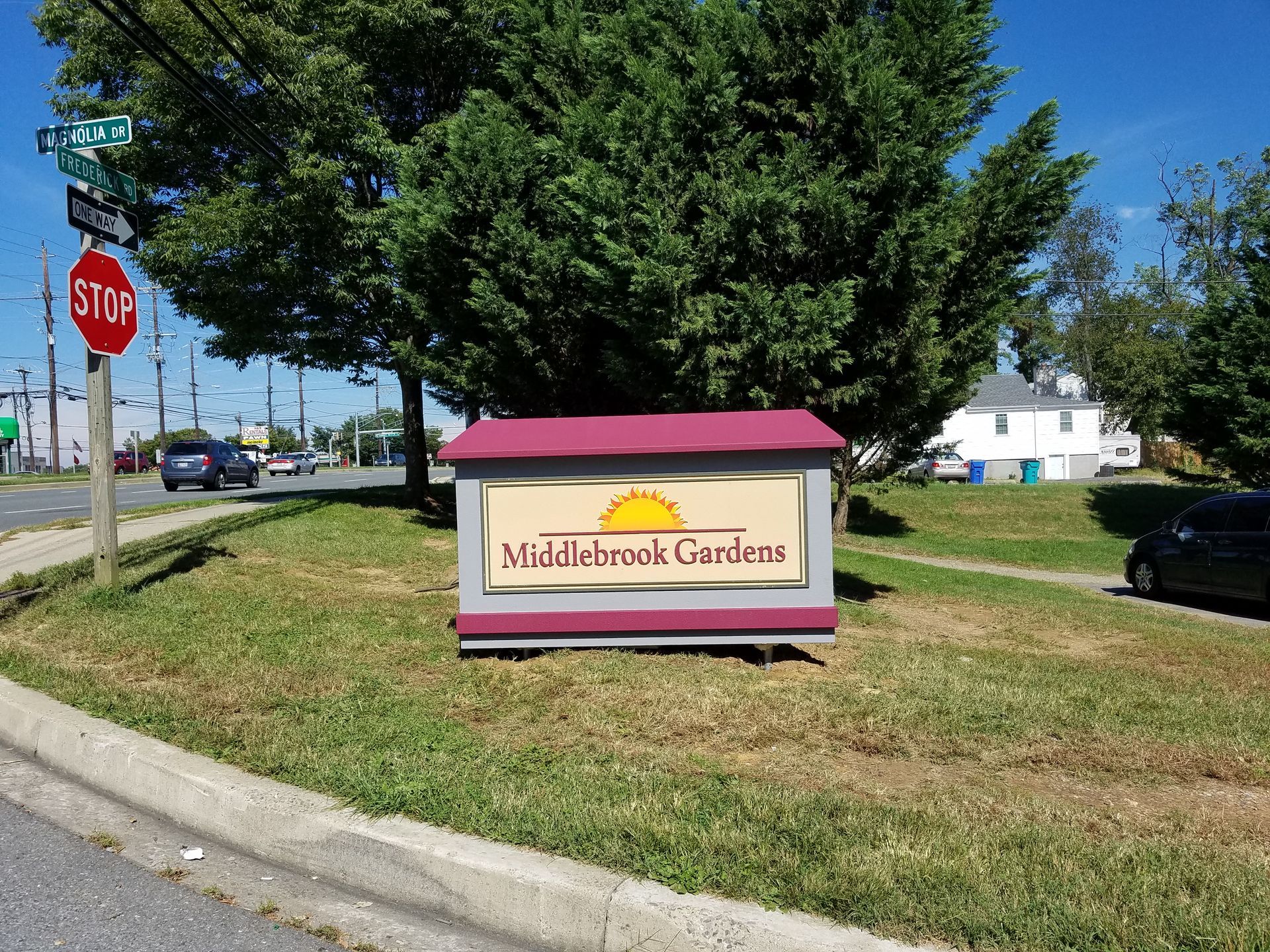 A stop sign is next to a sign that says middlebrook garden