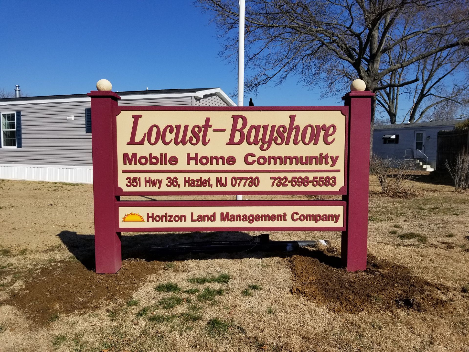 A sign for locust bayshore mobile home community