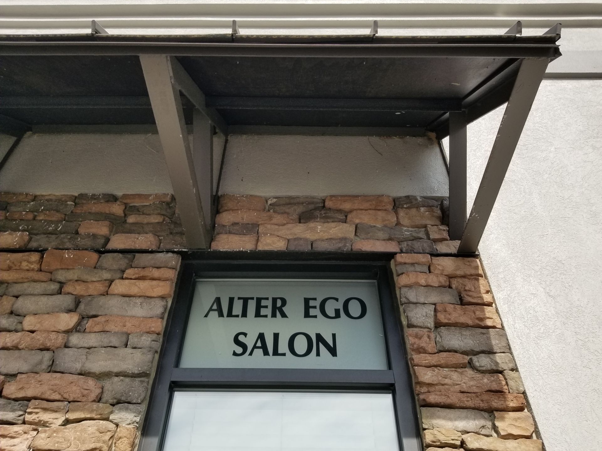 Alter ego salon is located on a brick building