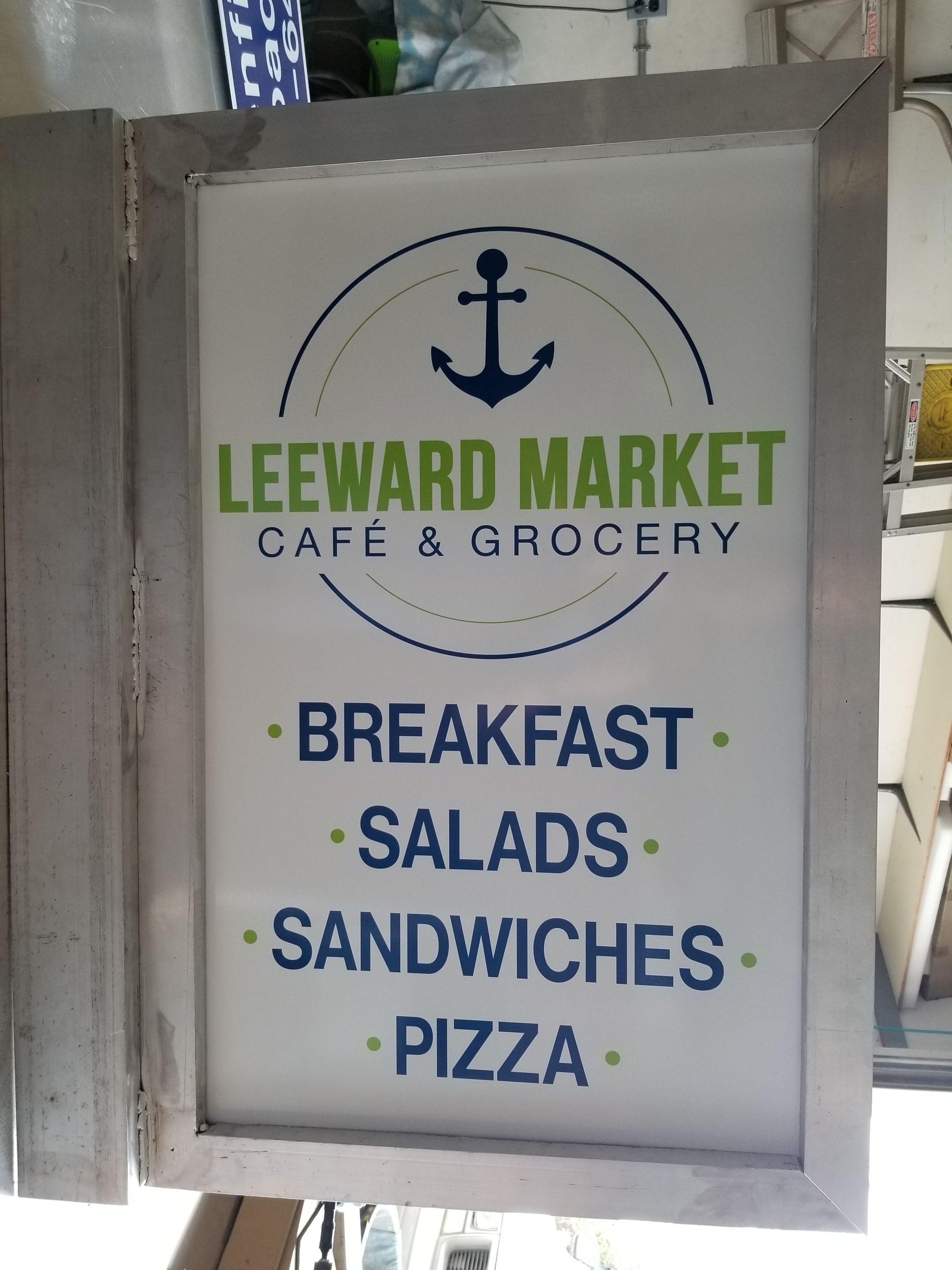 A sign for leeward market cafe and grocery