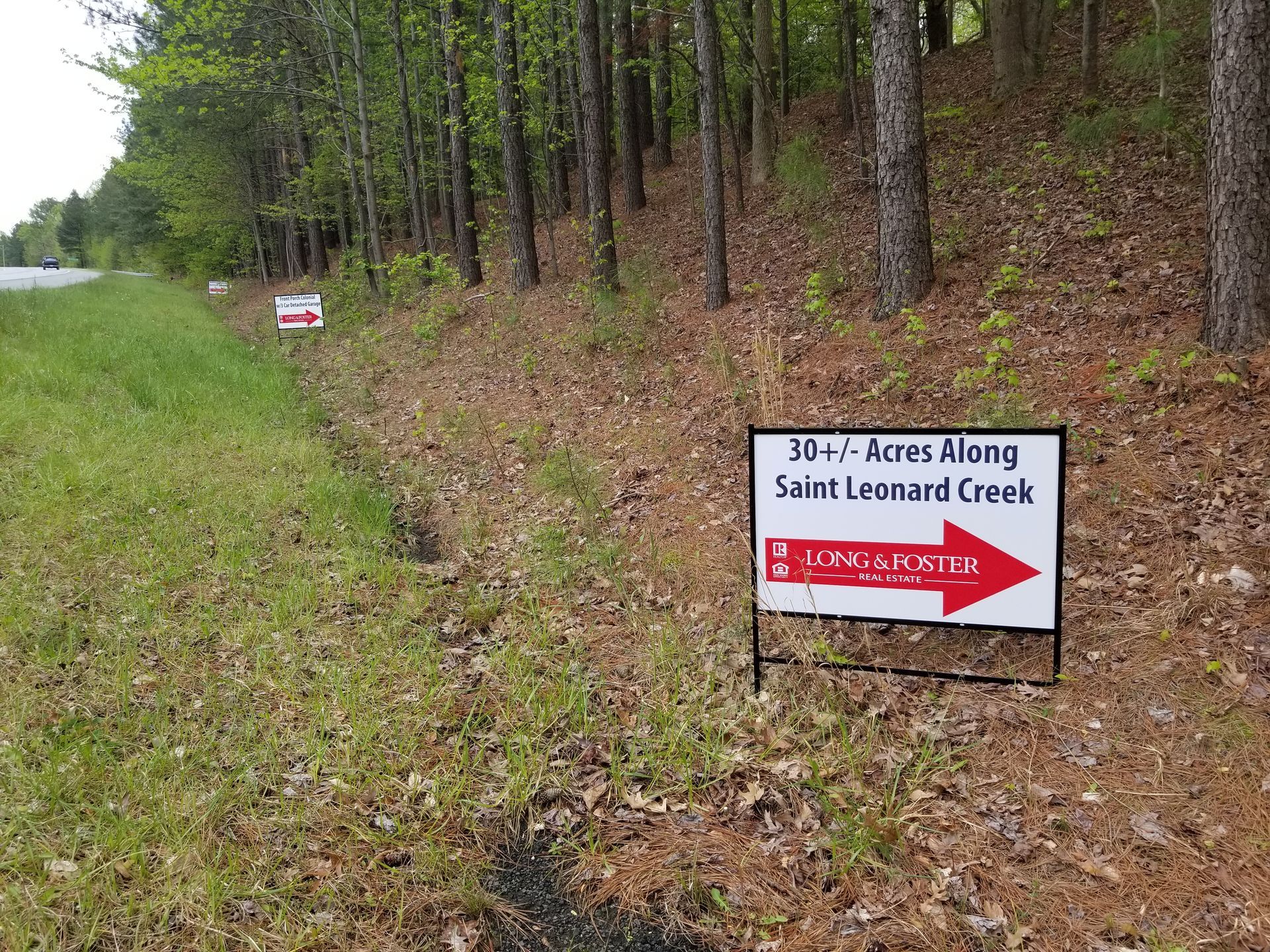 A sign on the side of a road shows the way to saint leonard creek.