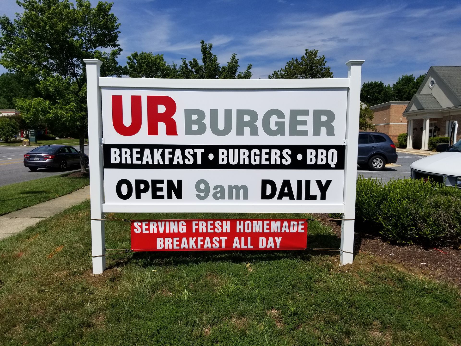 A sign that says ur burger breakfast burgers bbq open 9 am daily