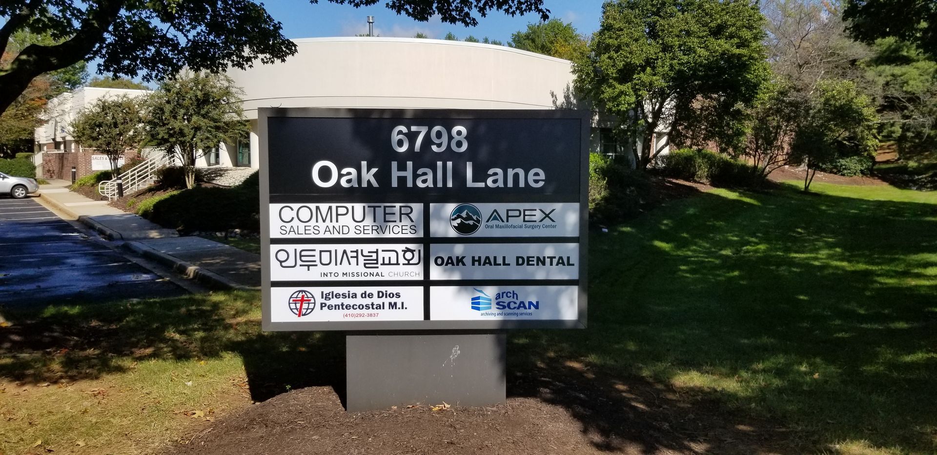 A sign for oak hall lane is in front of a building