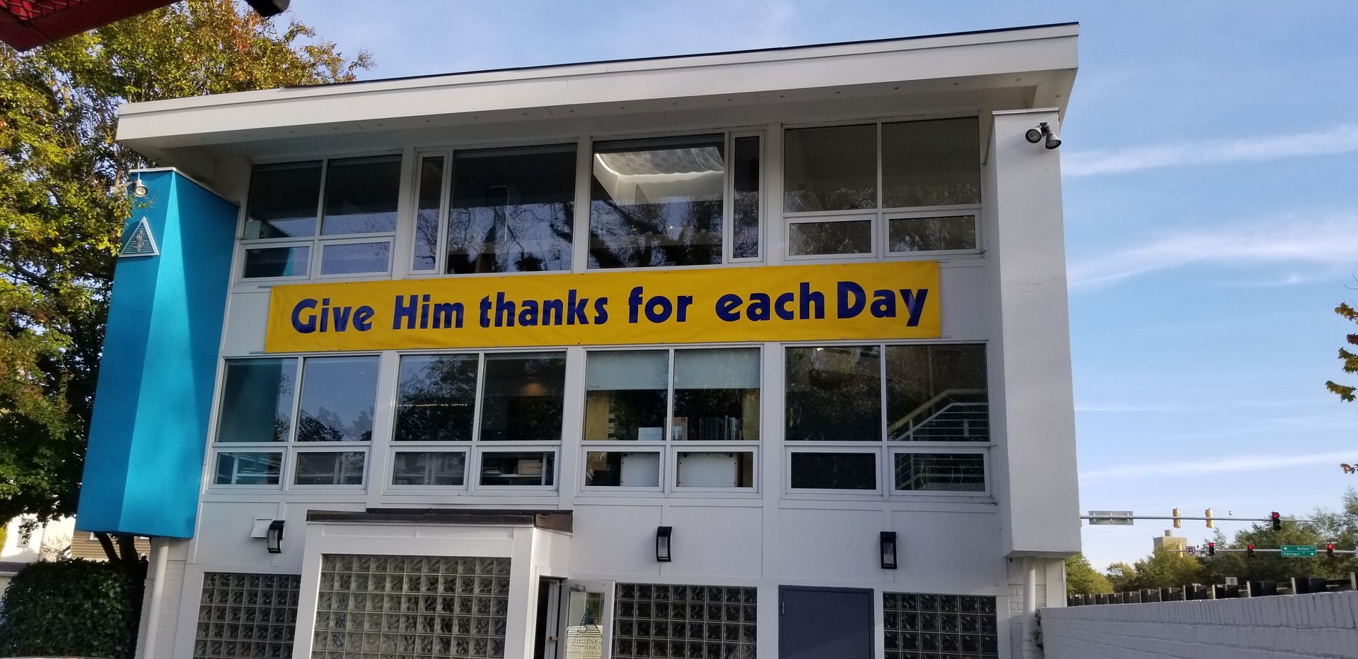 A building with a sign that says give him thanks for each day
