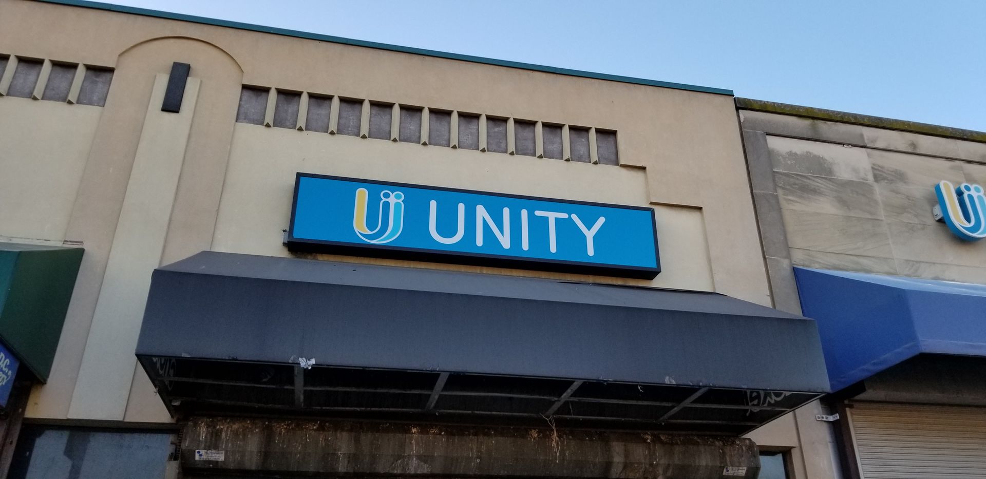 A building with a blue sign that says unity on it