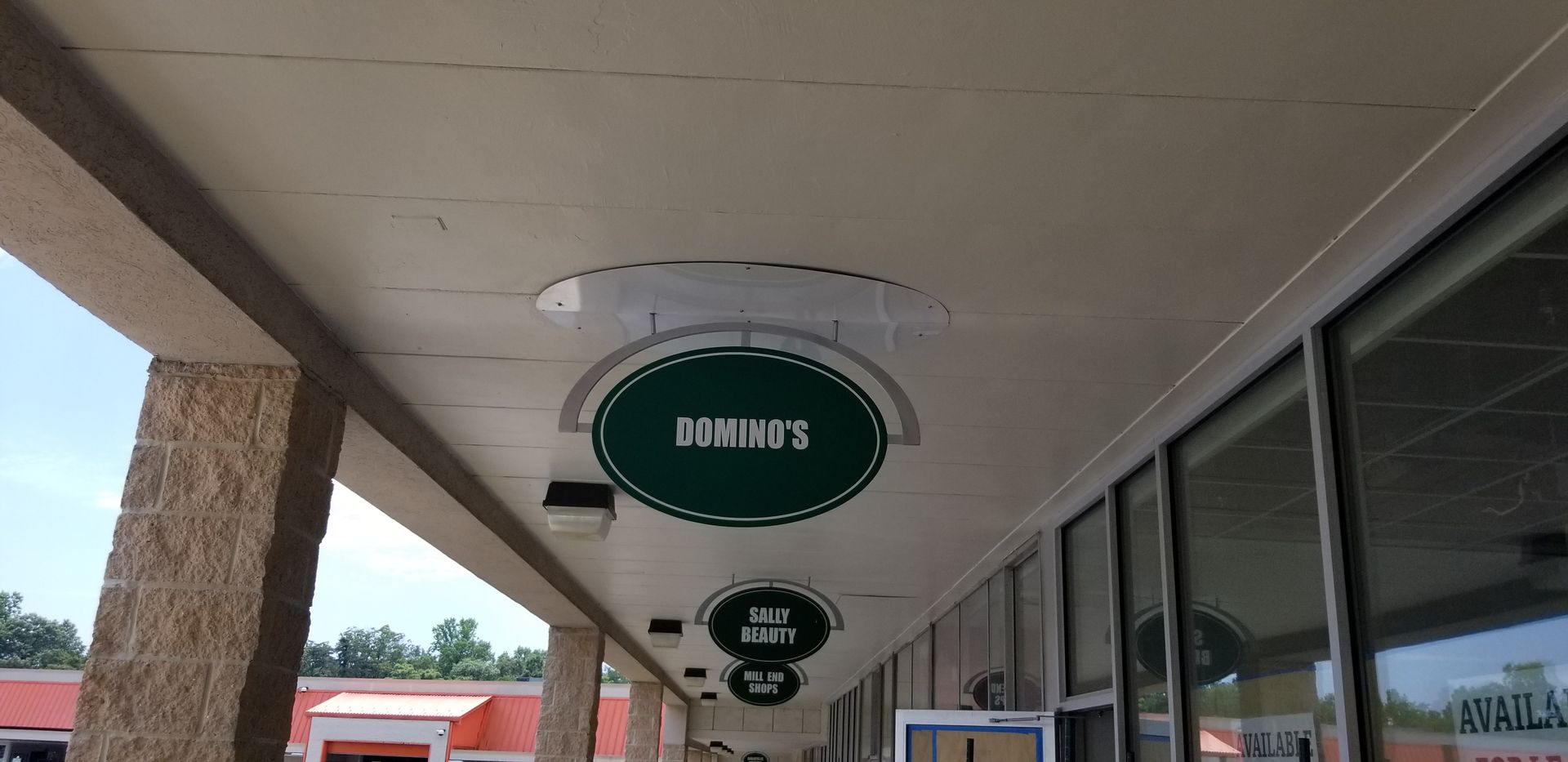 A domino 's sign hangs from the ceiling of a building