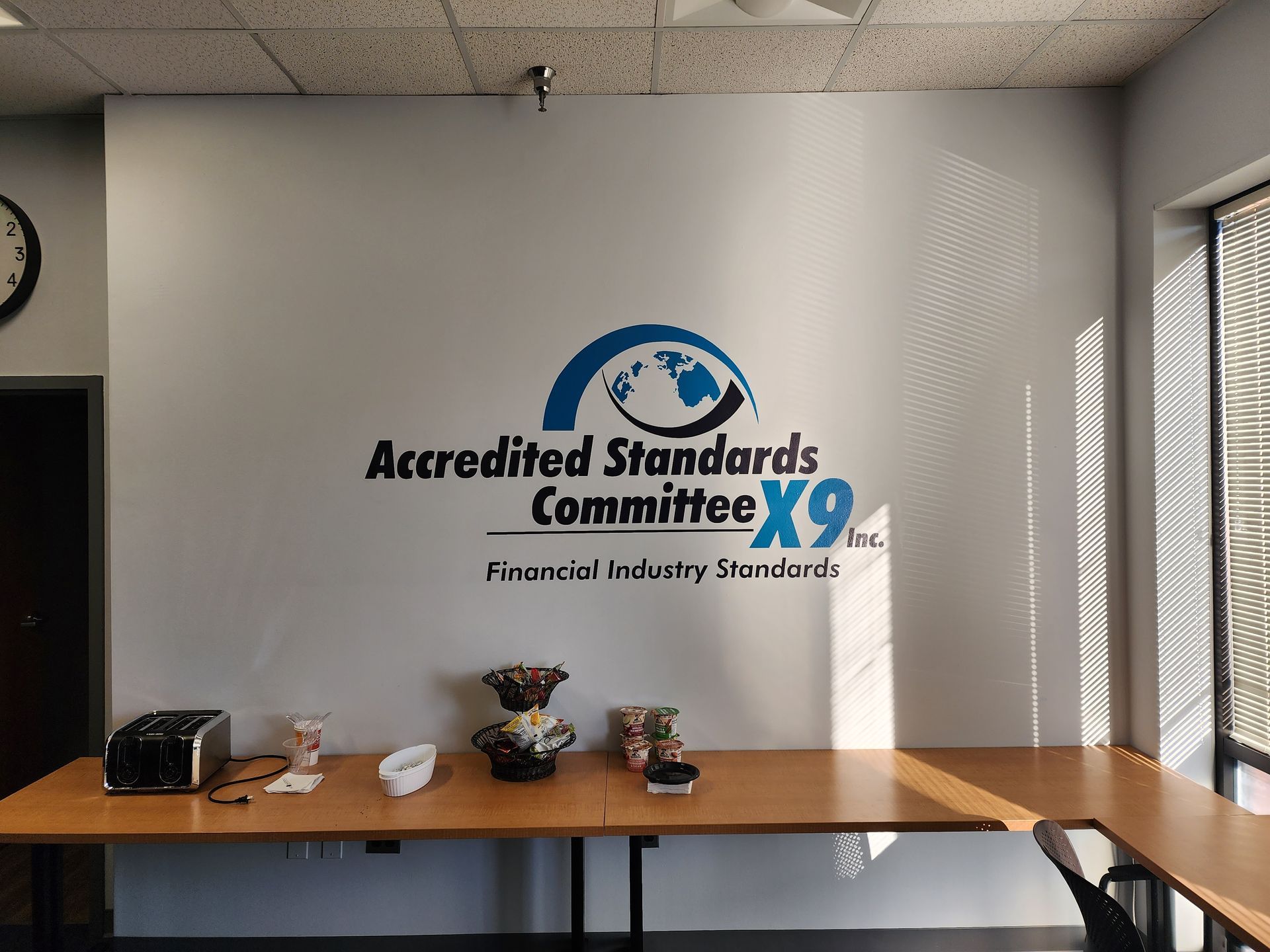 A room with a sign on the wall that says accredited standards committee x9
