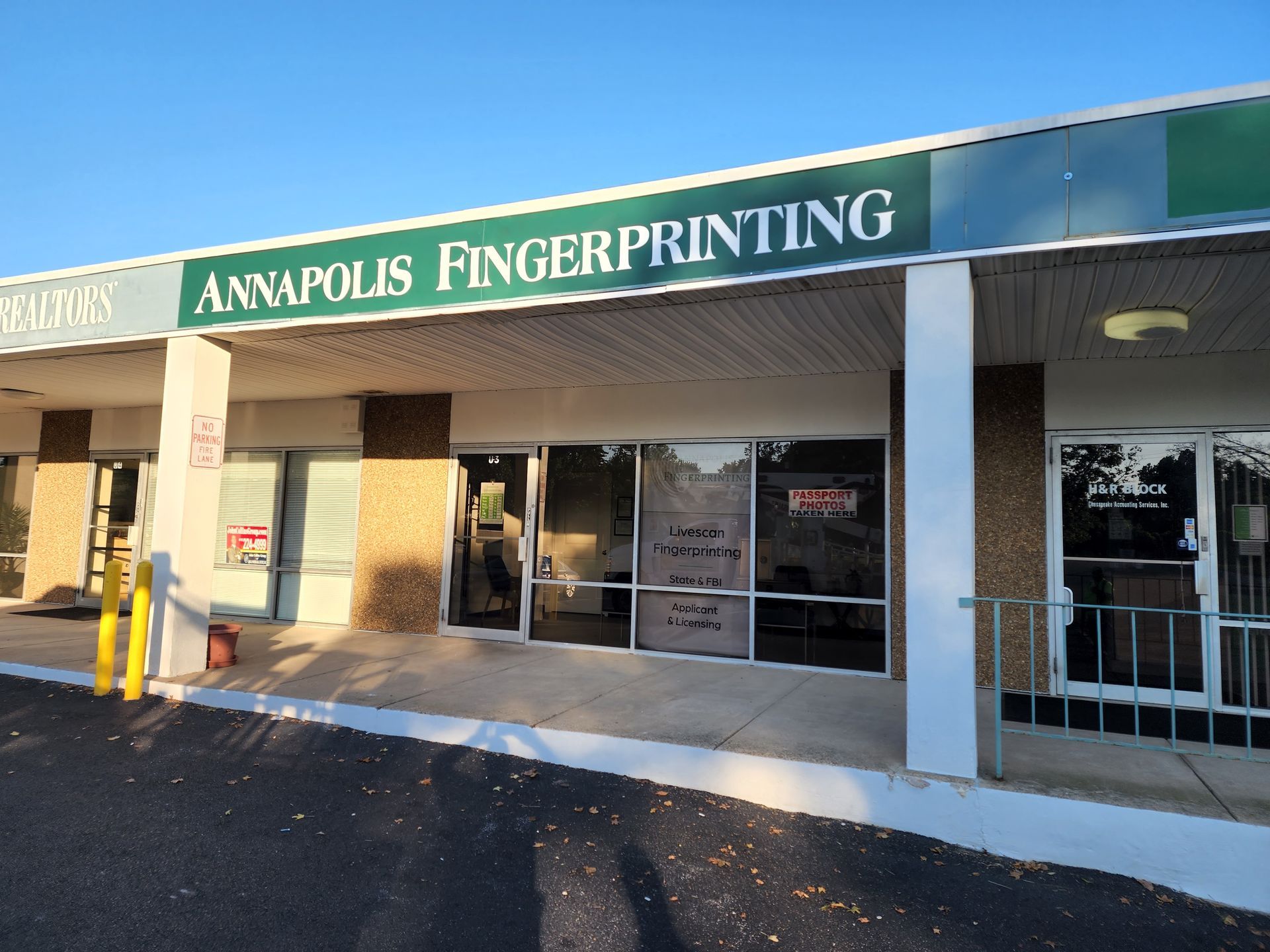 A building with a green sign that says annapolis fingerprinting
