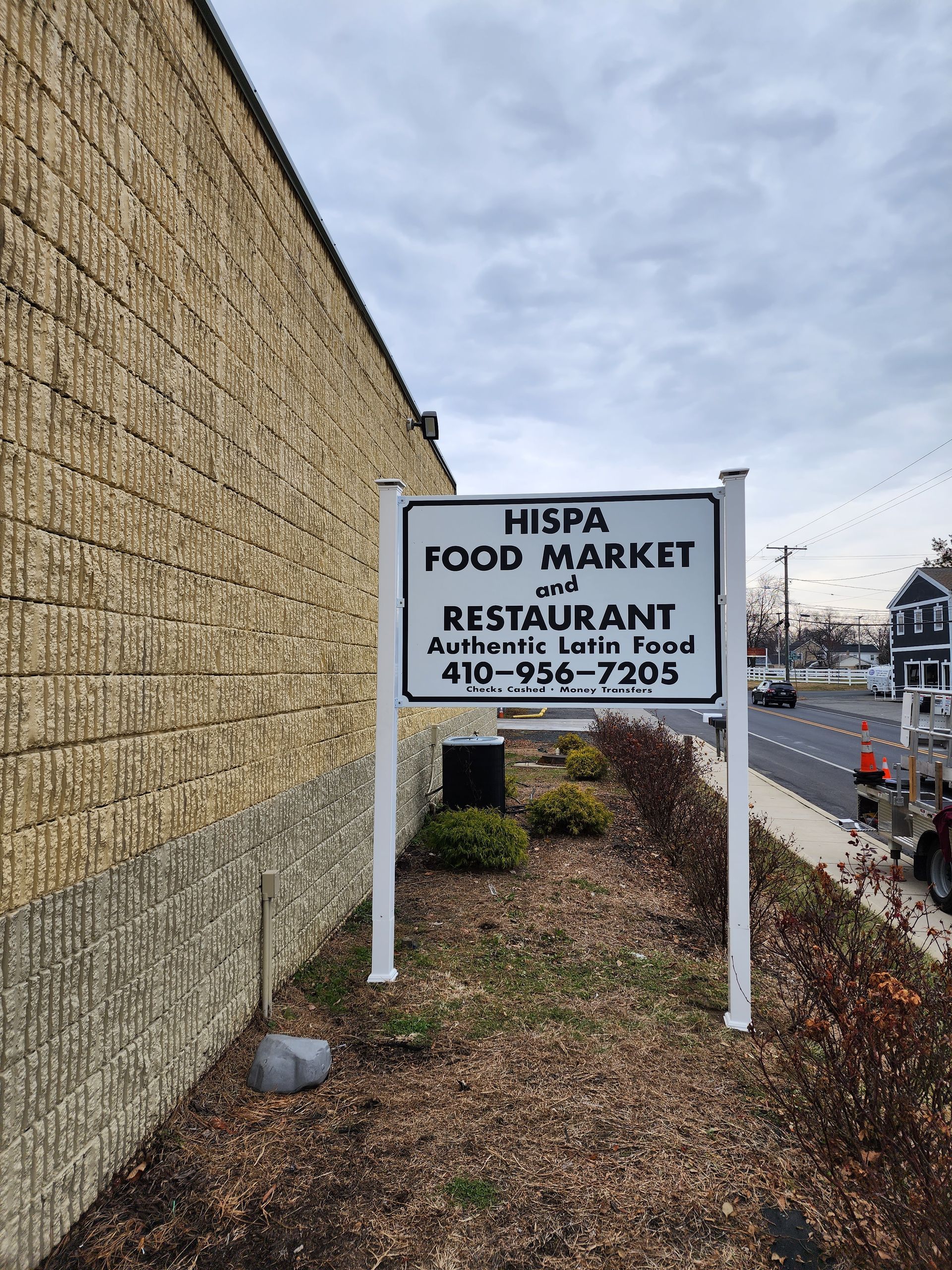 A sign for a restaurant is on the side of a building.