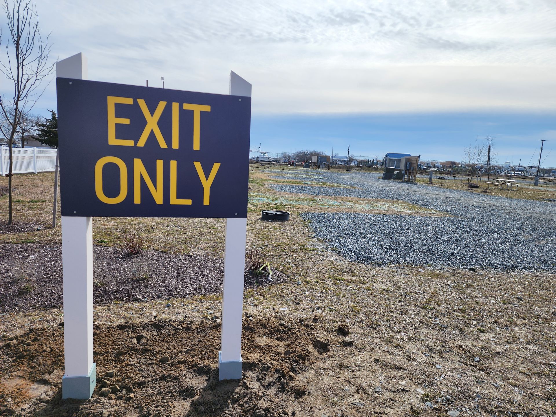 A blue and yellow sign that says exit only