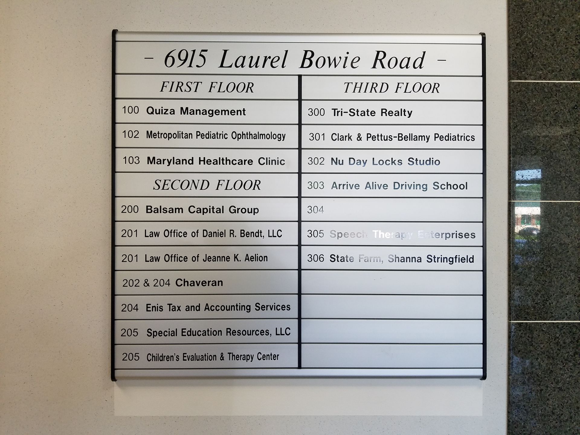 A sign that says 693 laurel bavie road on it