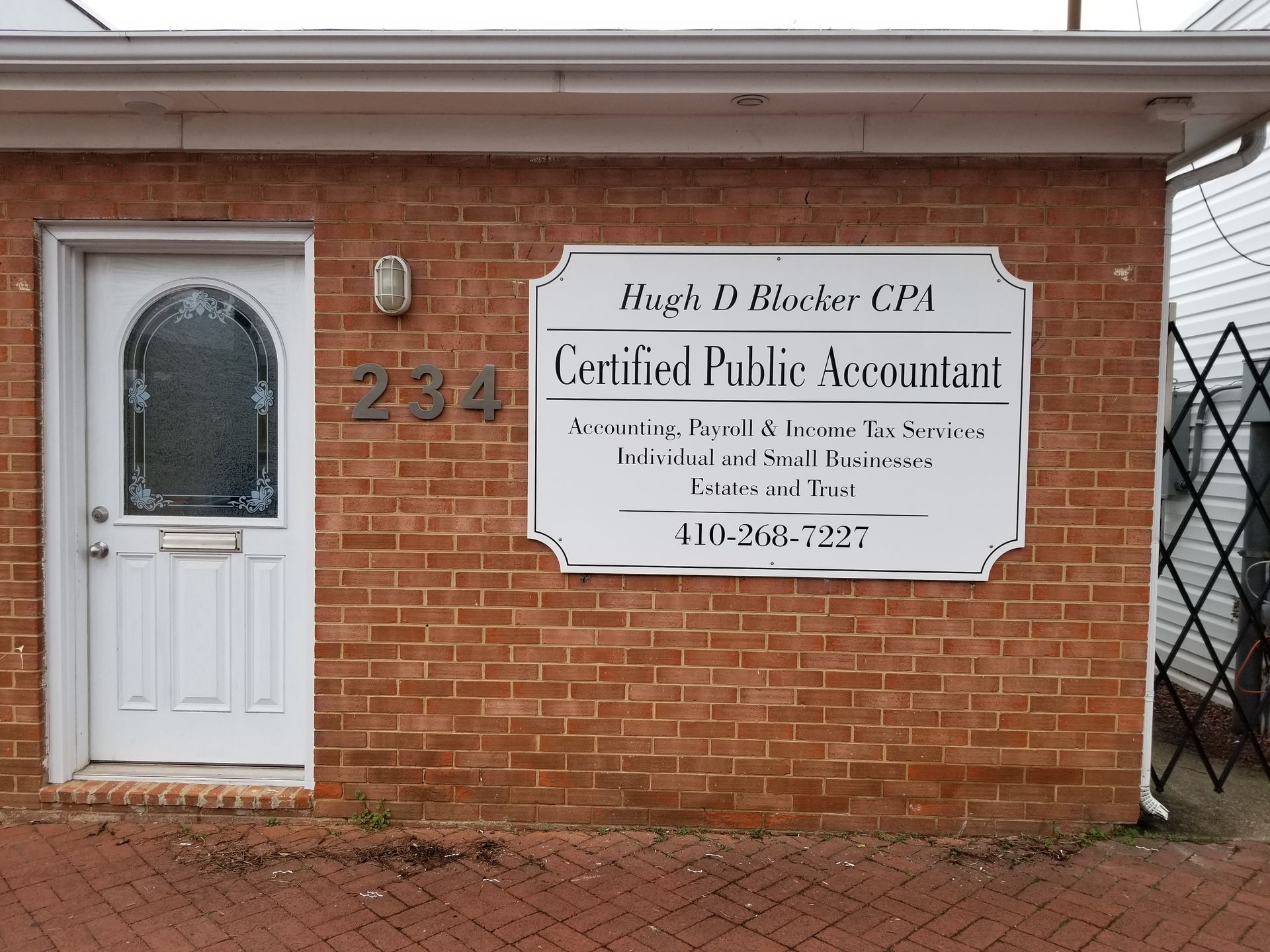 A brick building with a sign that says certified public accountant