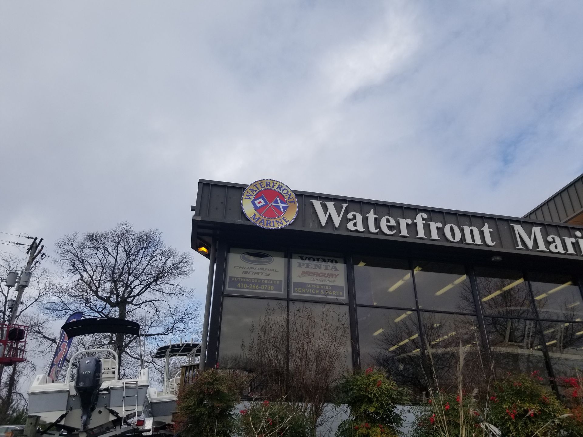 A boat is parked in front of a building that says waterfront marina.