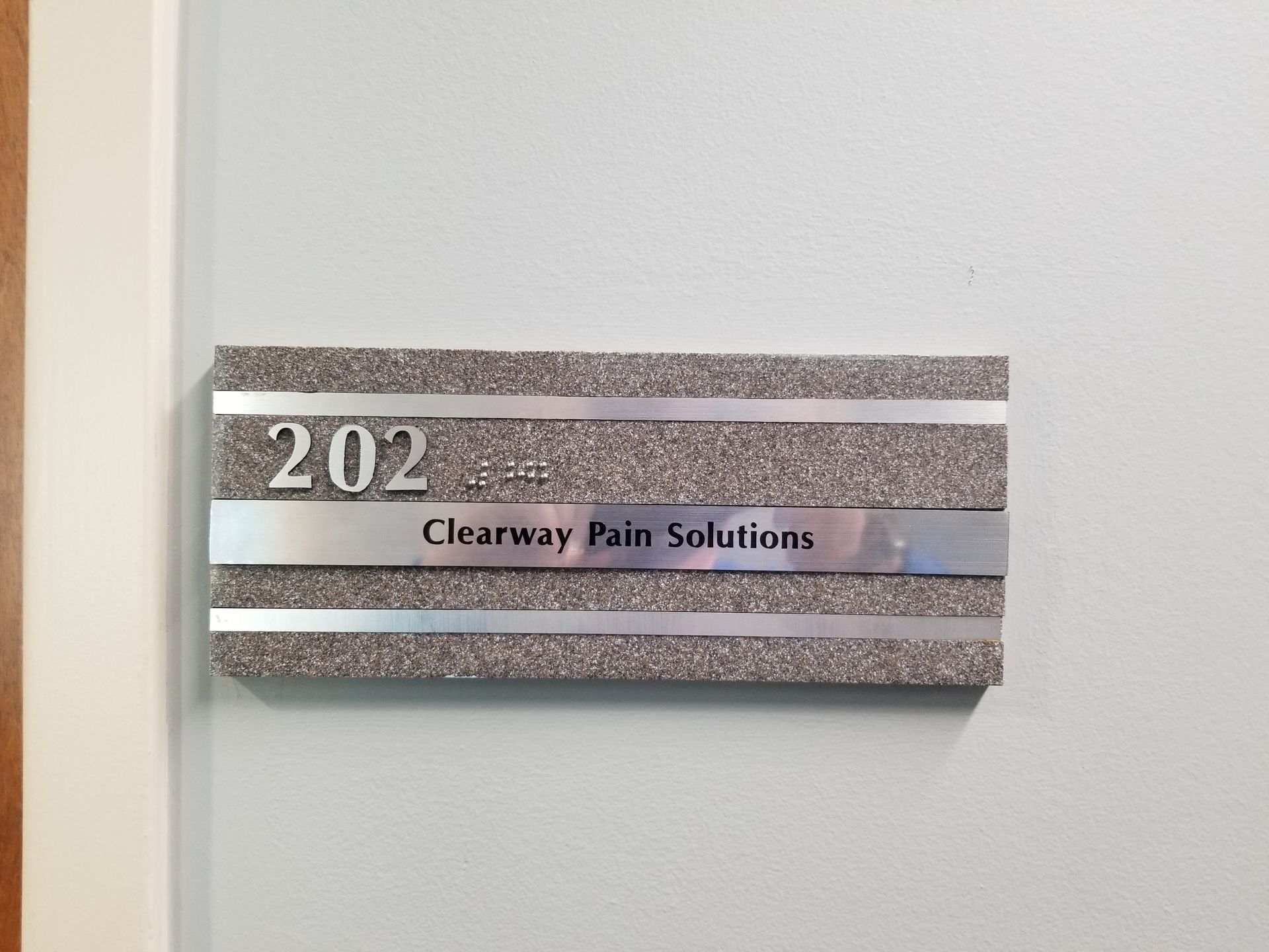 A sign on a door that says clearway pain solutions