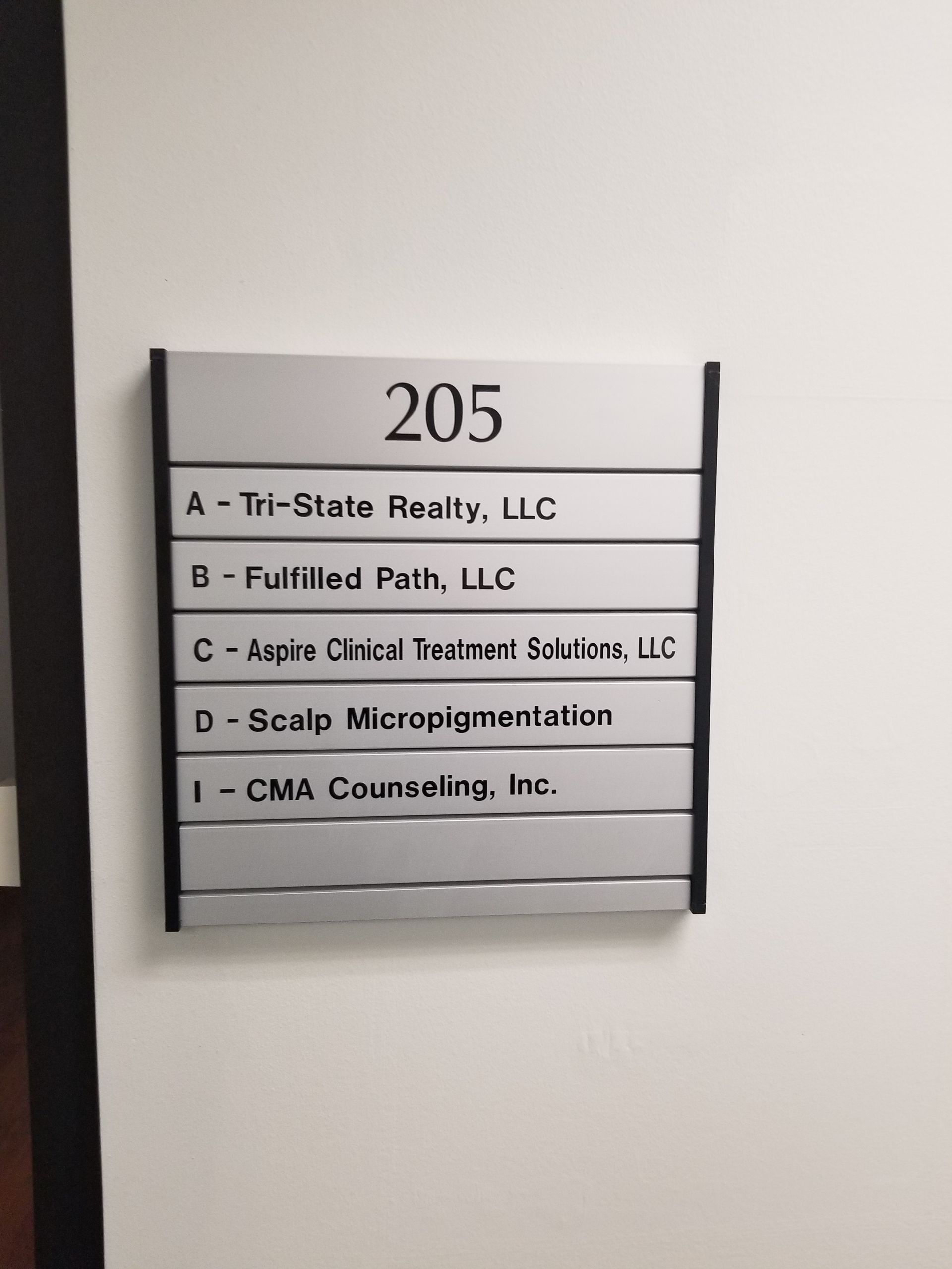 A sign on a wall that says 205 on it