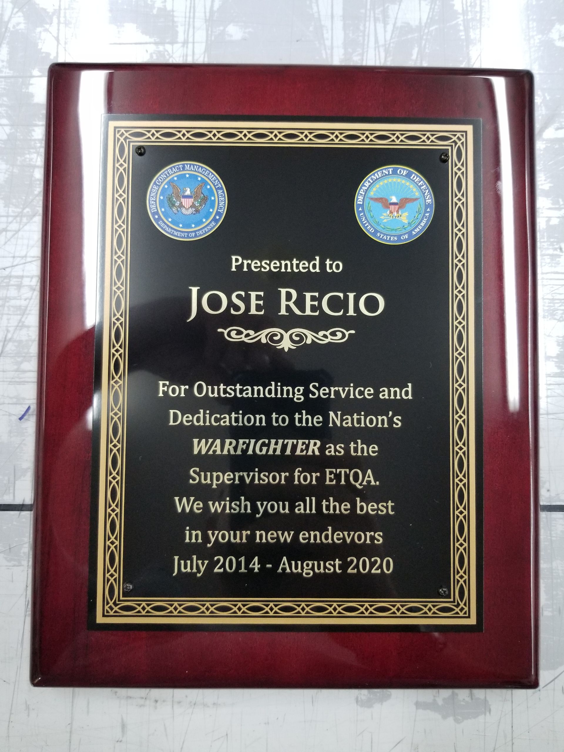 A plaque presented to jose recio for outstanding service and dedication to the nation 's warfighter