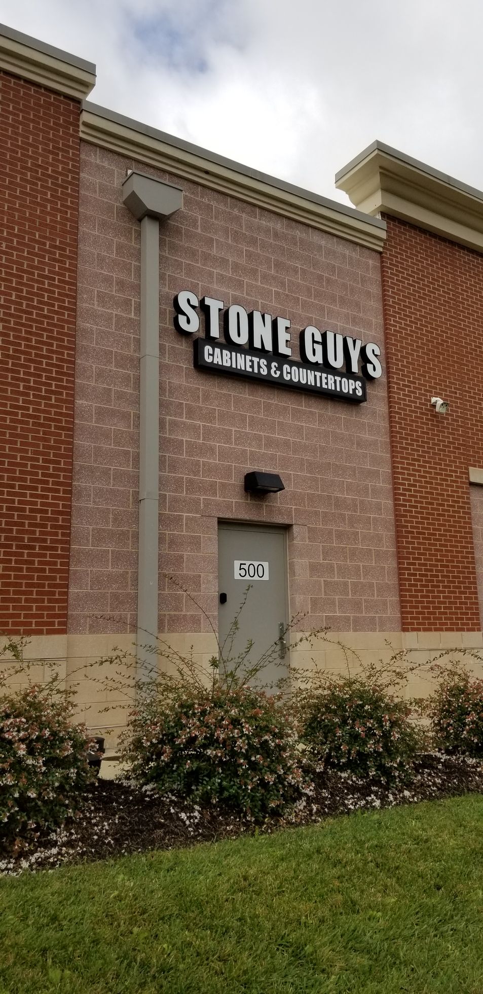 A brick building with a sign that says stowe guys on it.