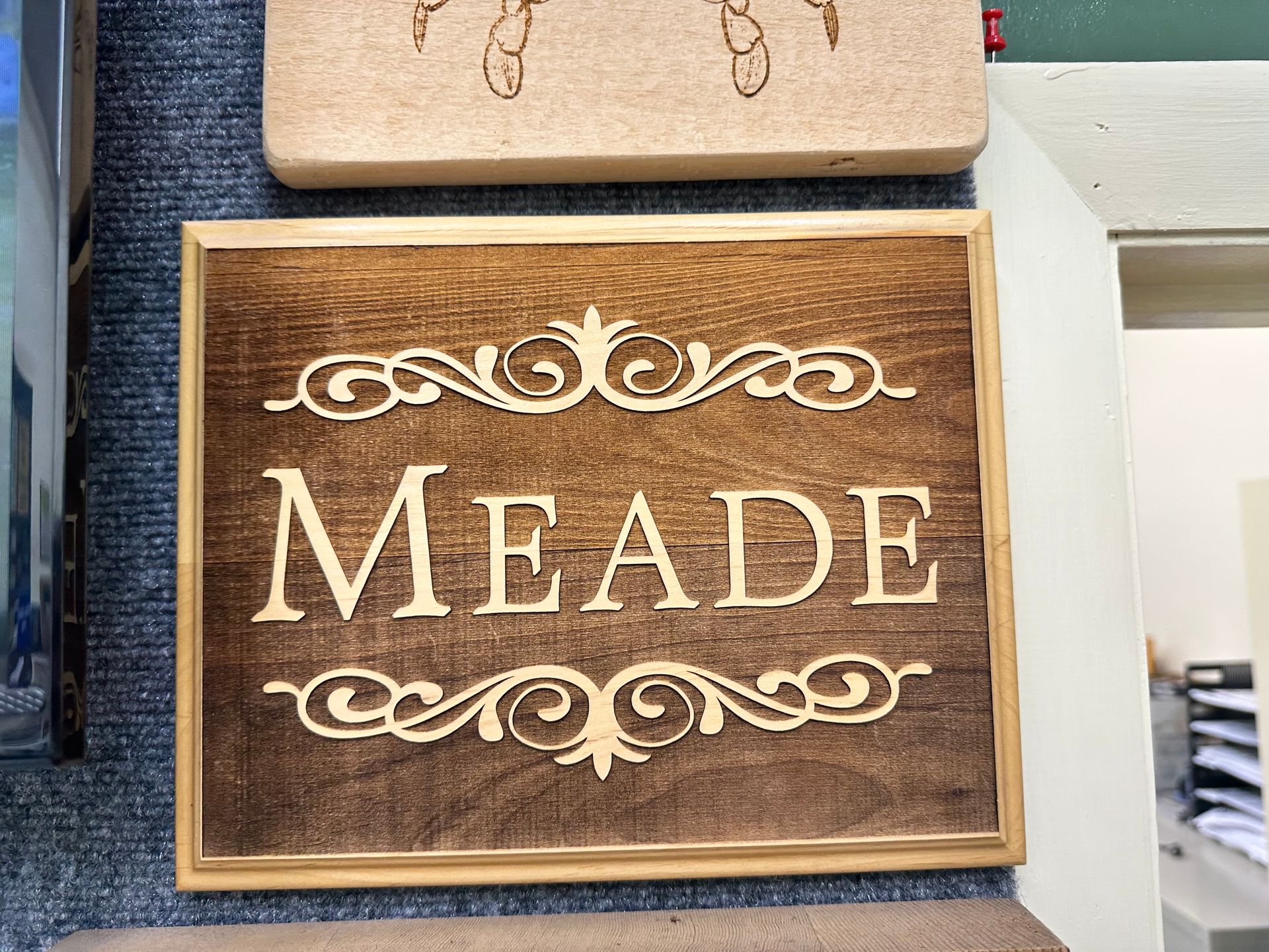 A wooden sign with the name meade on it