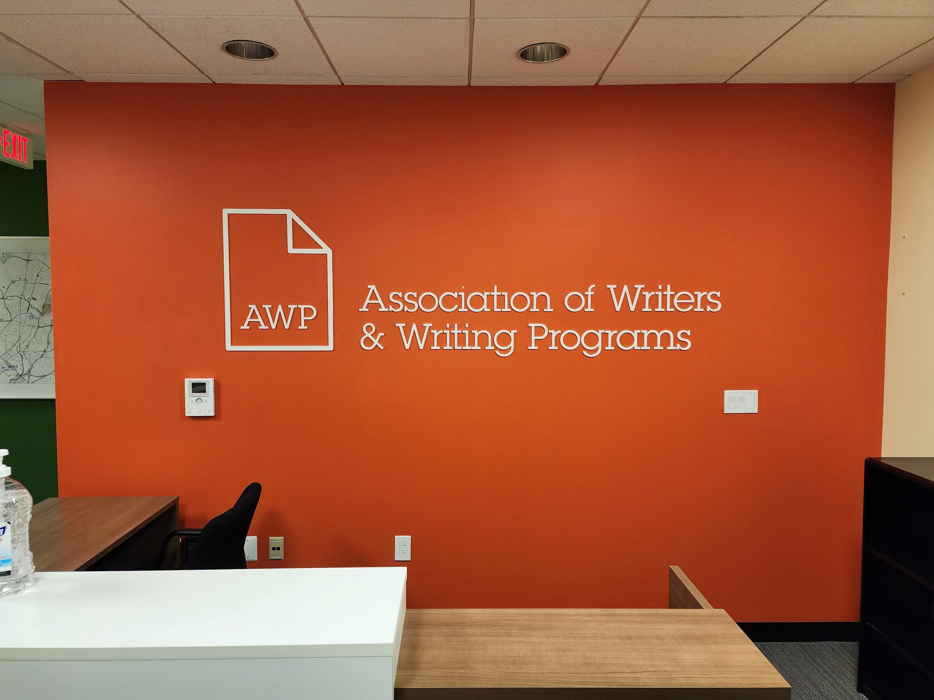 An orange wall with the words association of writers and writing programs on it