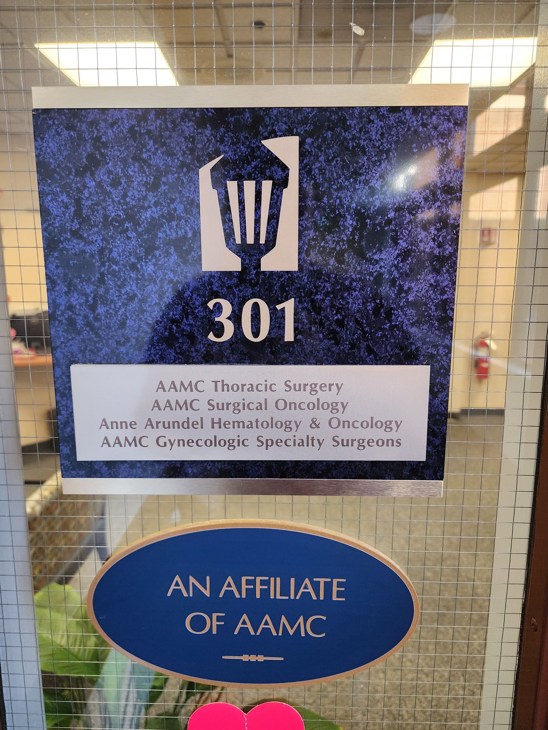 A sign on a glass door that says an affiliate of aamc