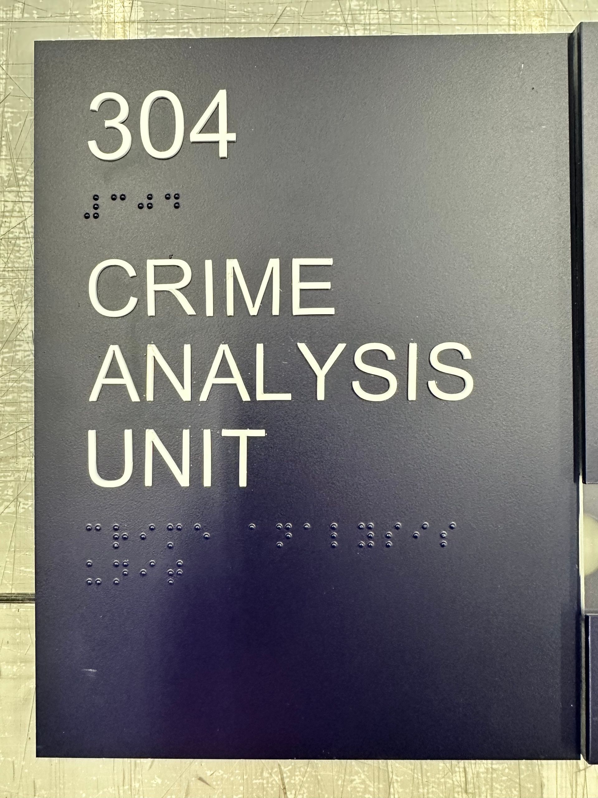 A braille sign for the 304 crime analysis unit