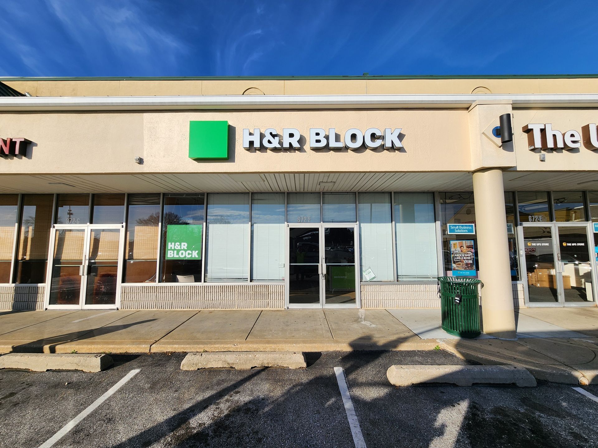 The front of a building with a green sign that says agr block