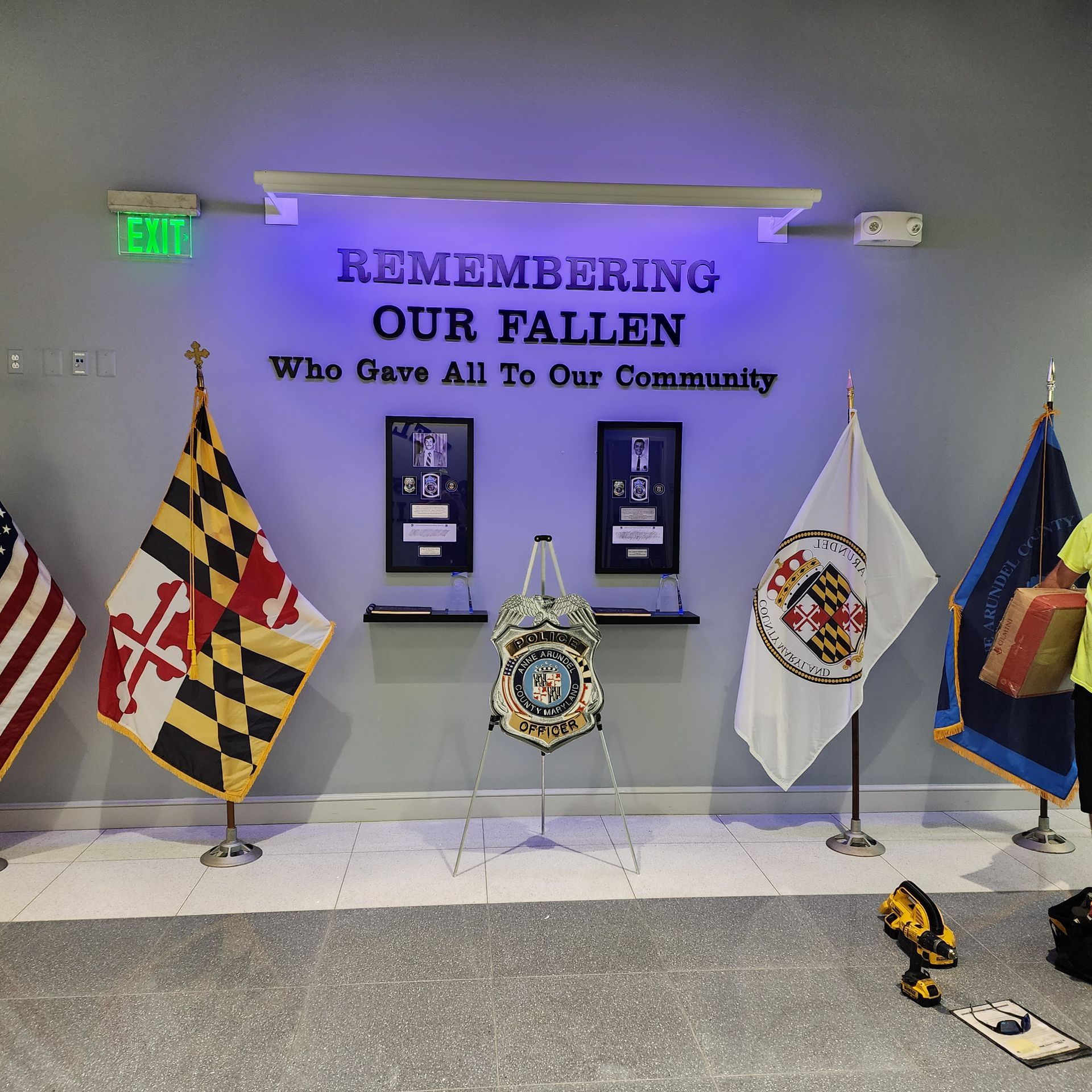 A sign that says remembering our fallen who gave all to our community