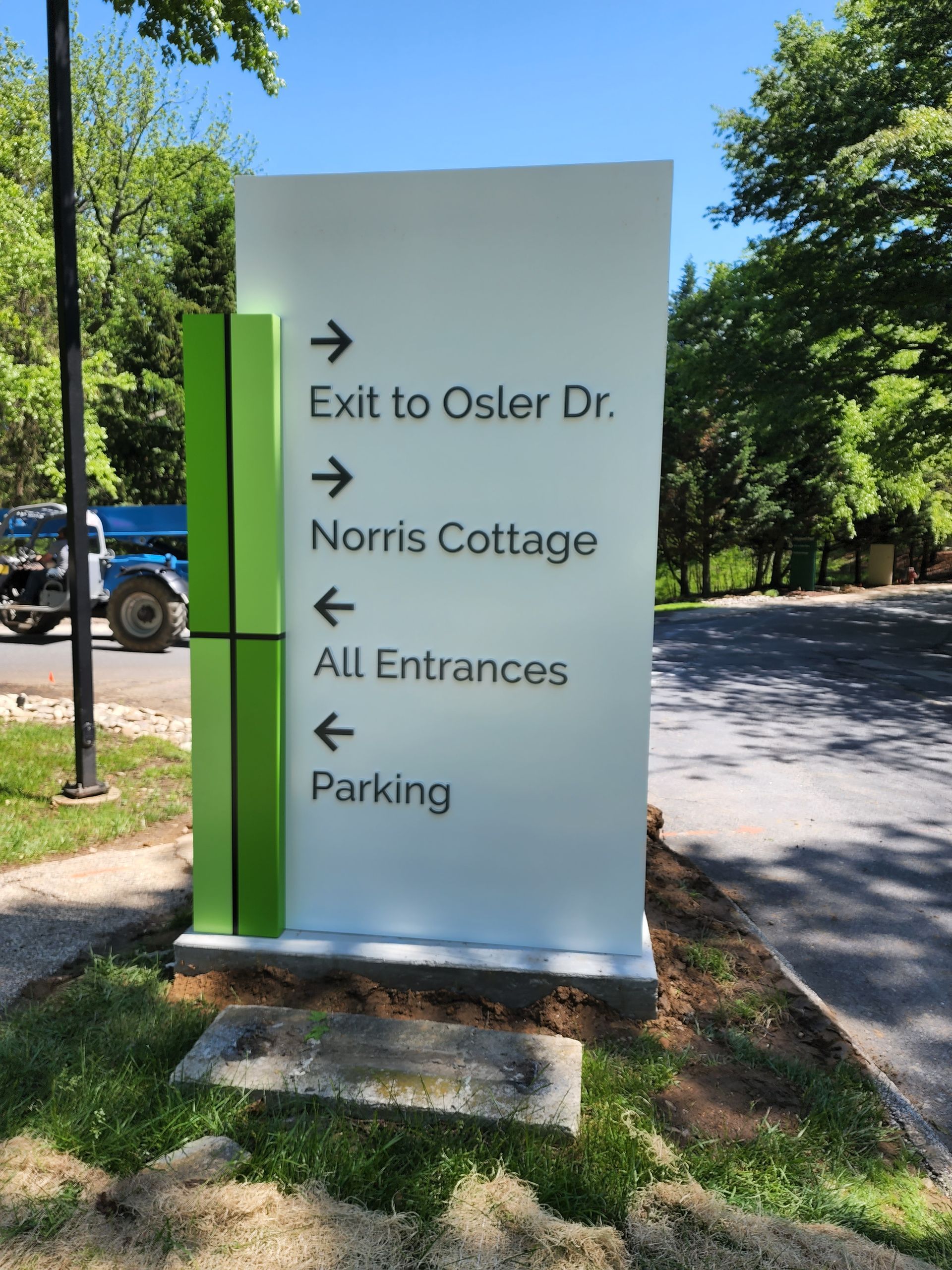 A sign that says exit to osler dr. norris cottage all entrances parking