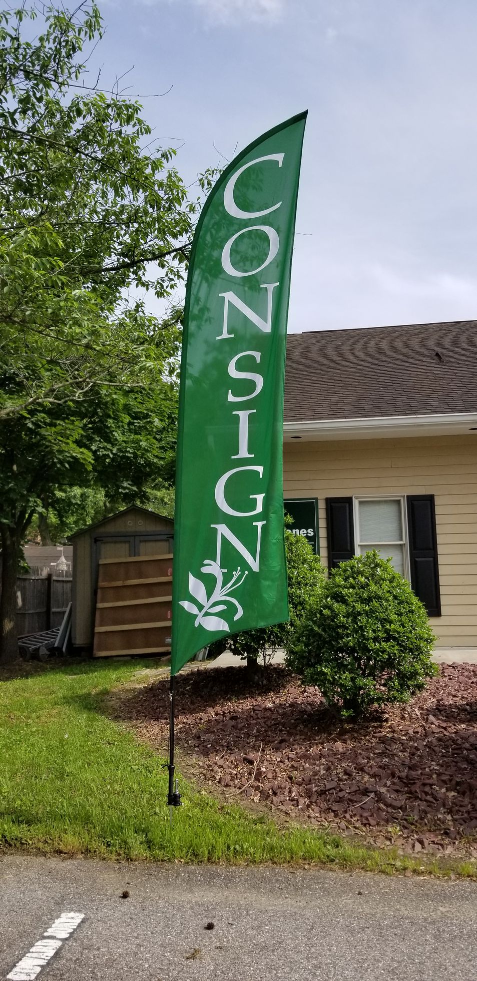 A green flag is sitting in front of a house.