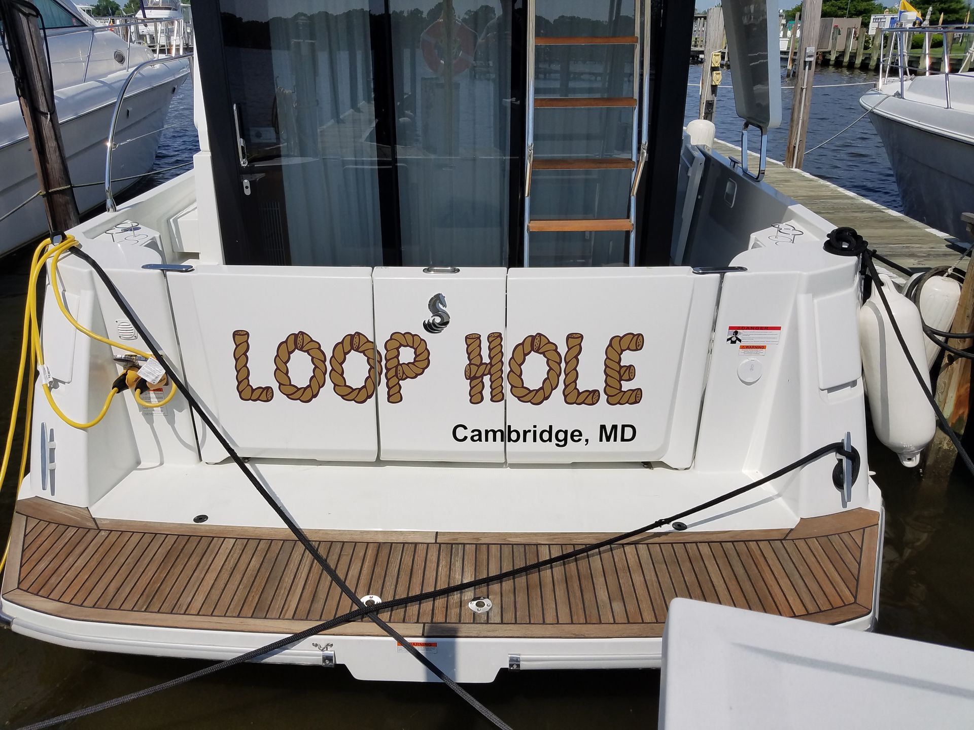 The back of a boat that says loop hole on it