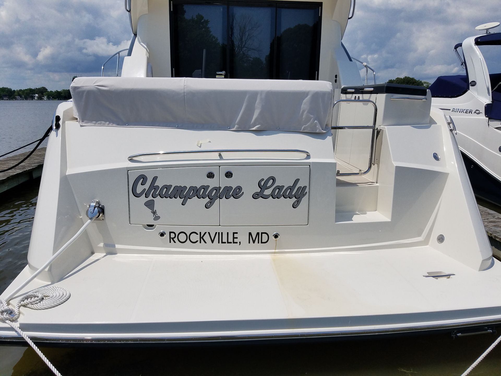 The back of a boat with the name champagne lady on it