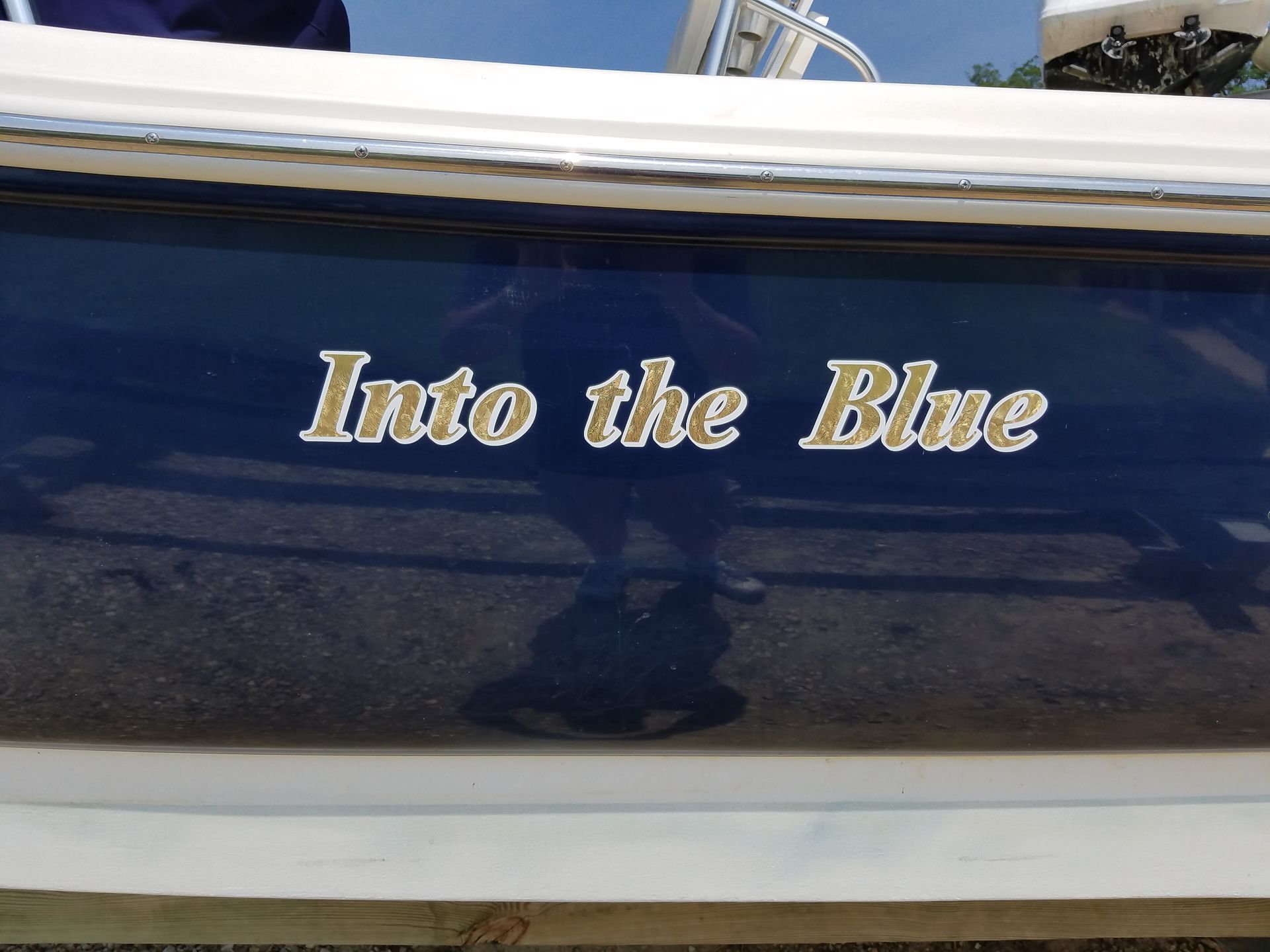 The name into the blue is on the side of a boat