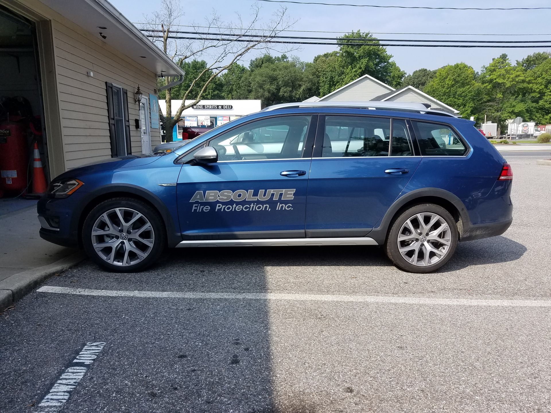 A blue volkswagen golf is parked in a parking lot.