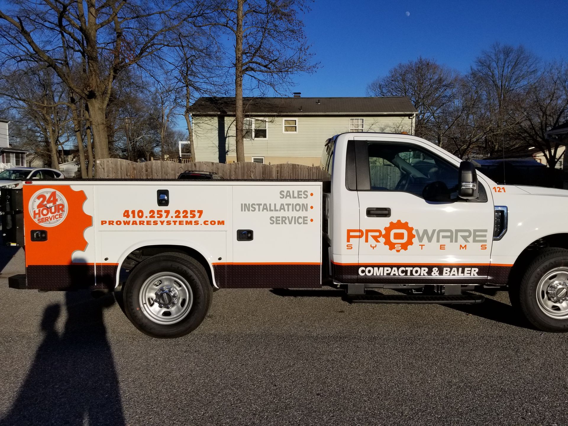 A proware truck is parked in front of a house
