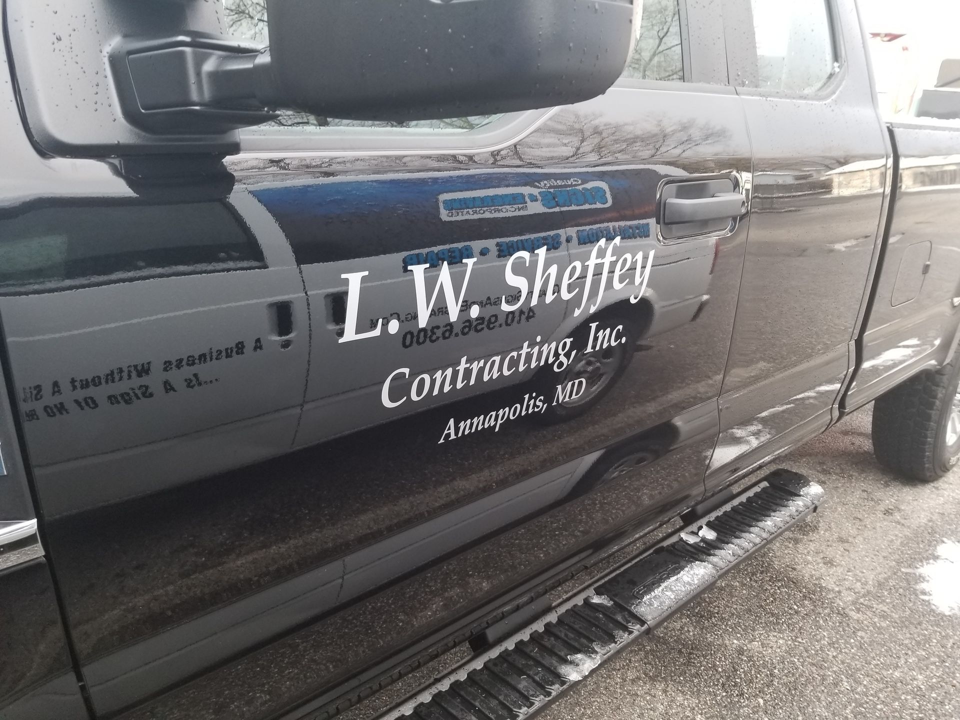 A black truck with l.w. sheffey contracting inc. written on the side
