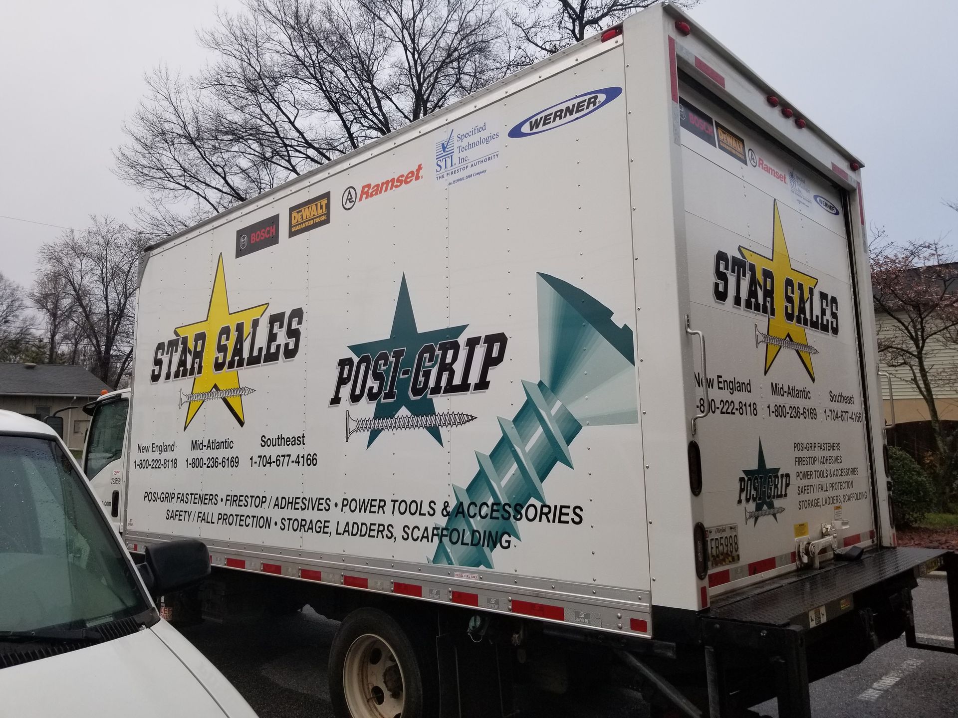 A star sales truck is parked on the side of the road