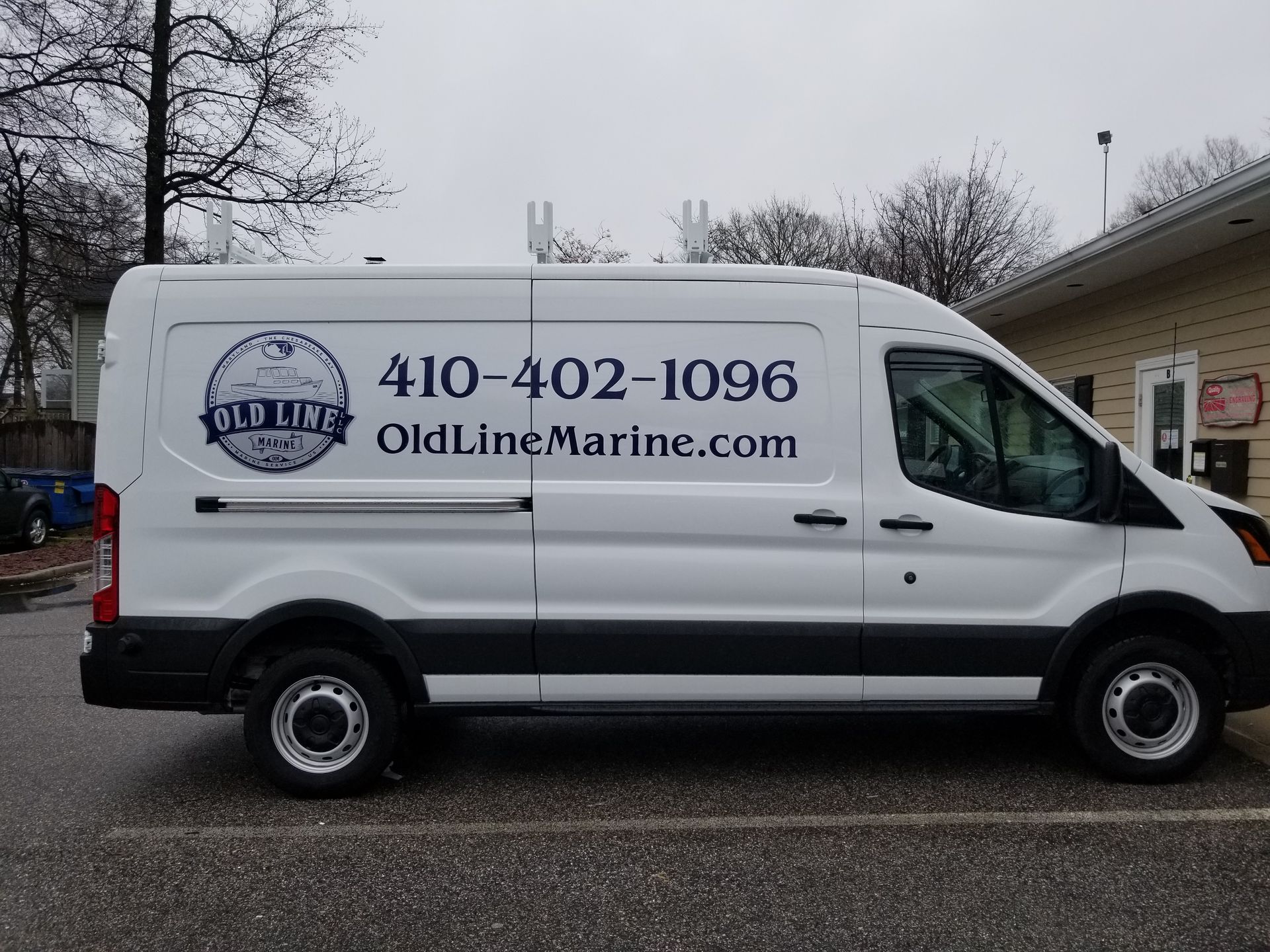 A white van with oldlinemarine.com written on the side
