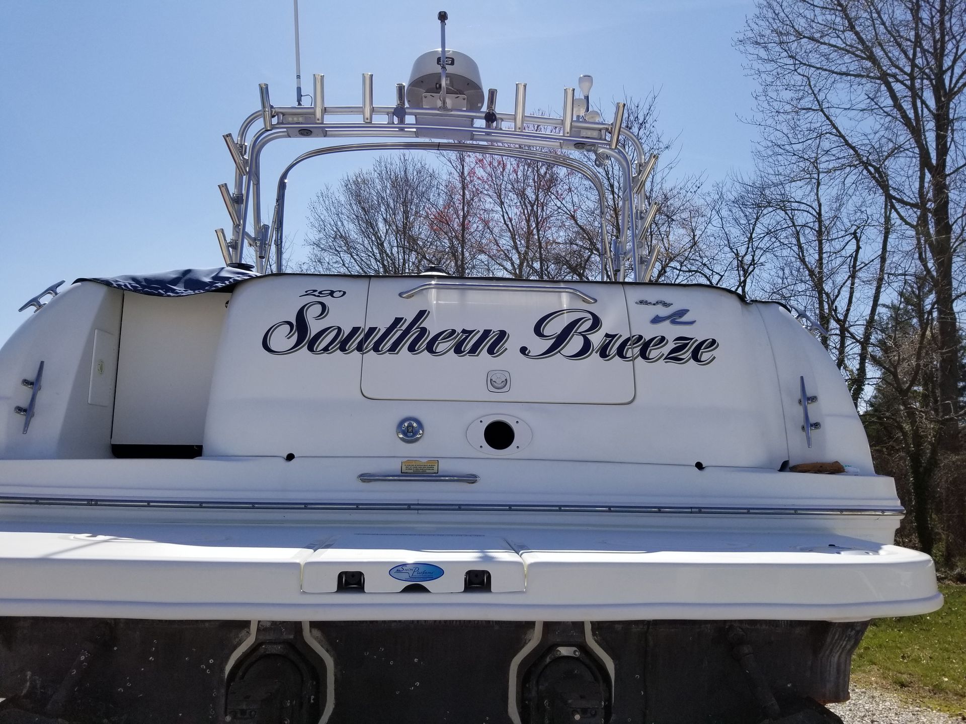 A white boat with the name southern breeze on the back