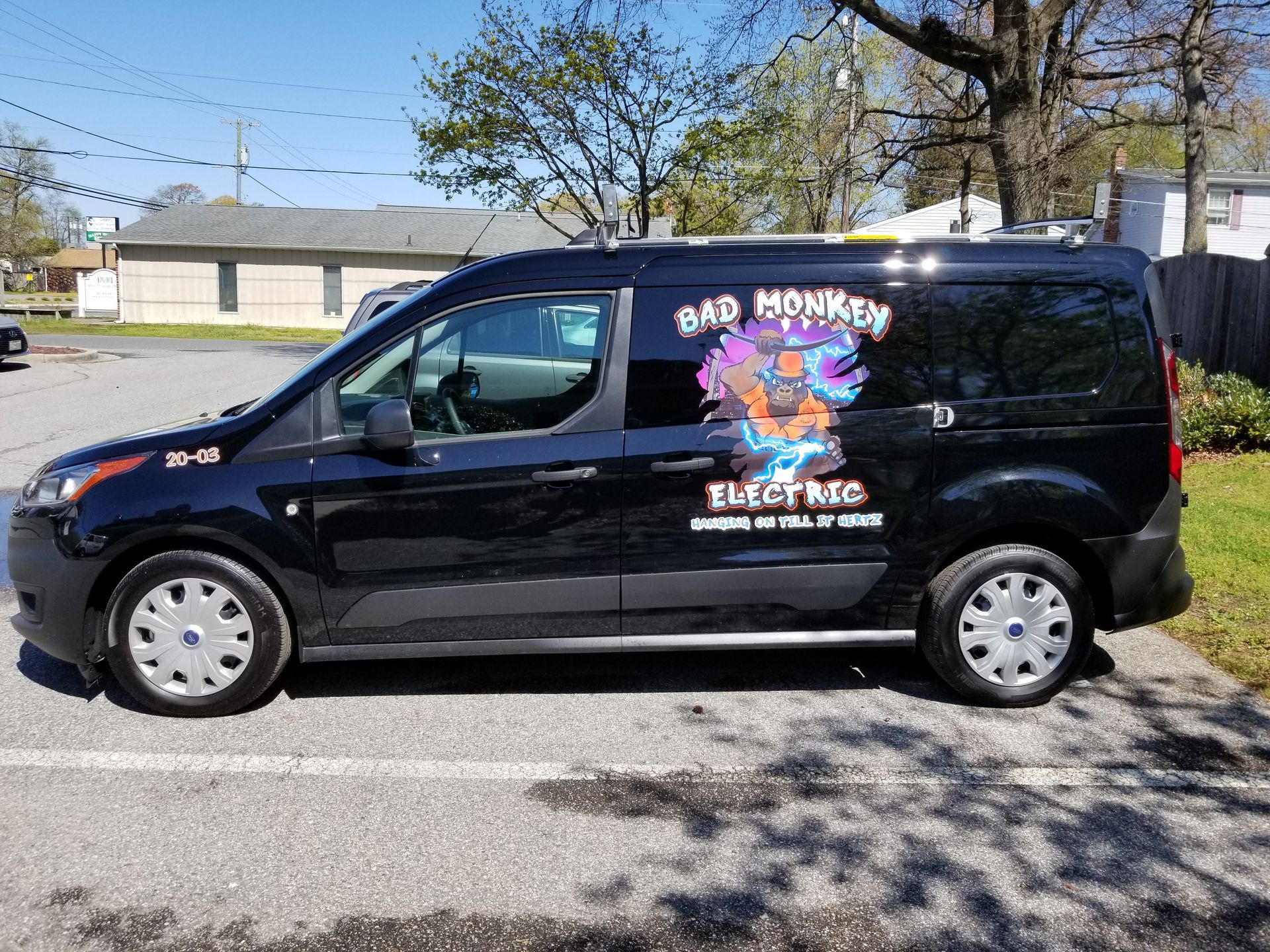A black van is parked in a parking lot.