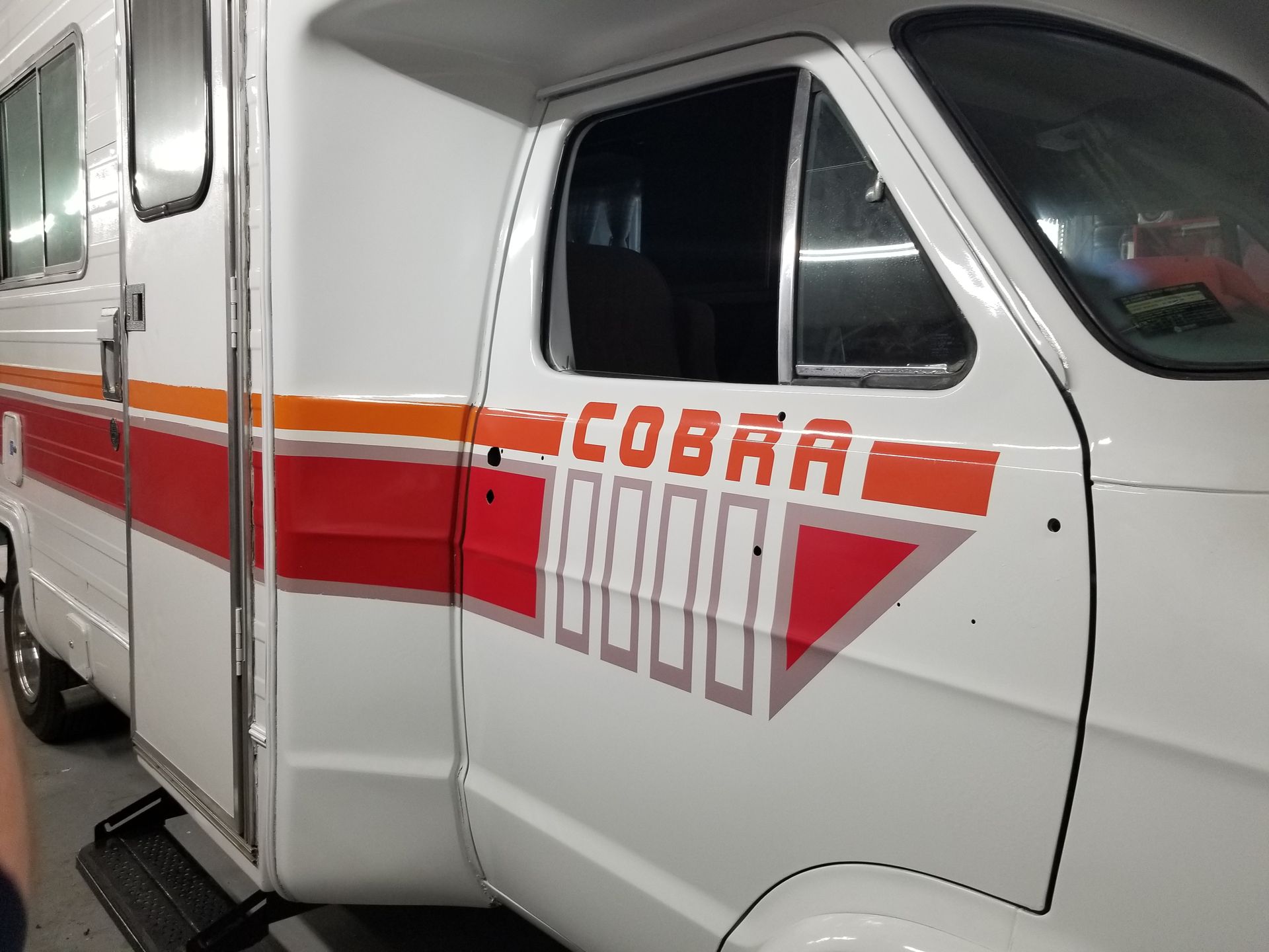 A white and red ambulance with the word cobra on the side