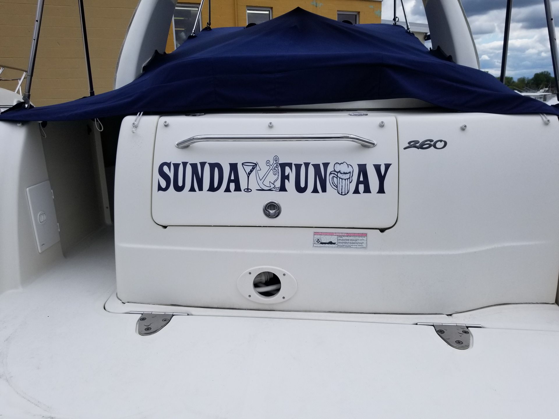 The back of a boat with a sign that says sunday fun day