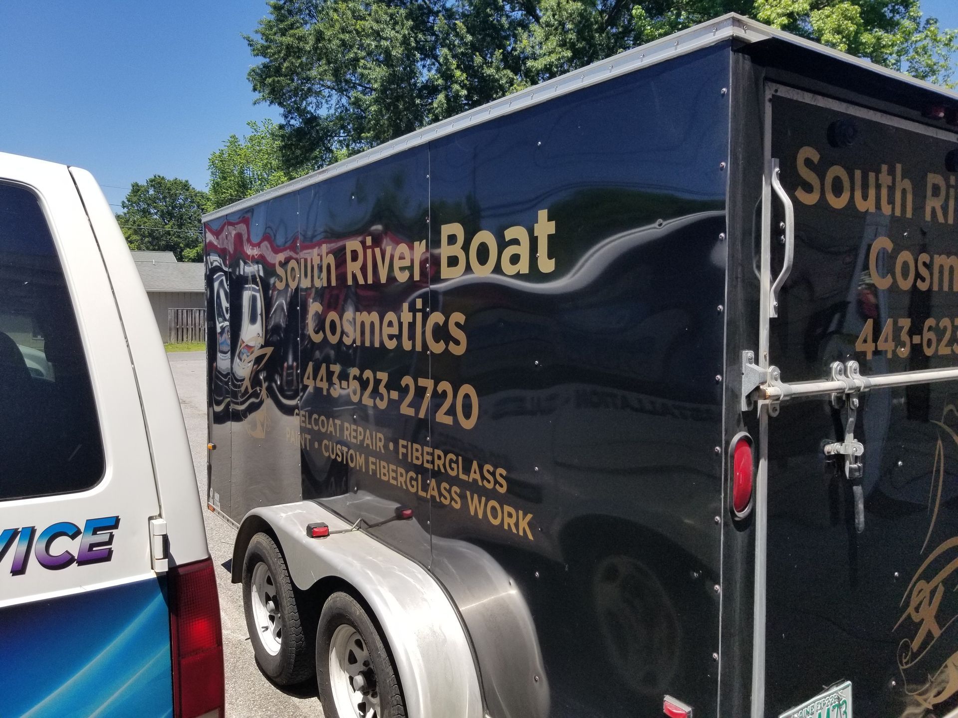 A black trailer that says south river boat cosmetics on it
