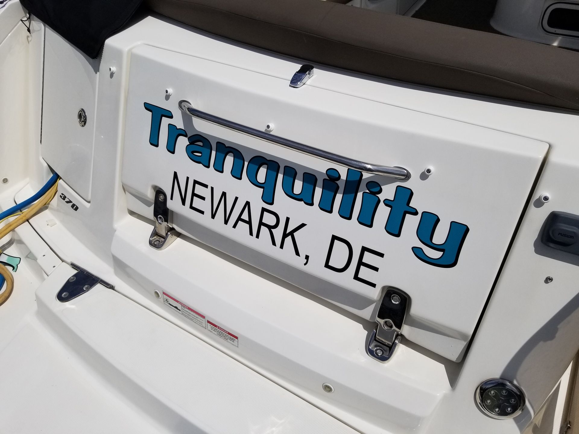 The back of a boat with tranquility newark de written on it